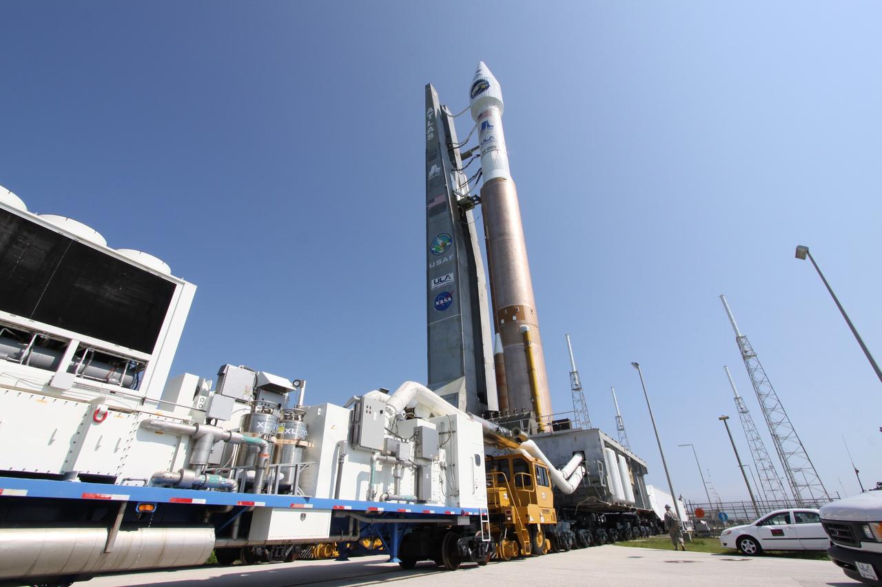 CAPE CANAVERAL, Fla. –   On Launch Complex-41 on Cape Canaveral Air Force Station in Florida, the Atlas V/Centaur rocket with NASA's Lunar Reconnaissance Orbiter, or LRO, and NASA's Lunar Crater Observation and Sensing Satellite, known as LCROSS, on top roll out to the launch pad.  At right are the protective lightning towers that surround the pad.  LRO and LCROSS are the first missions in NASA's plan to return humans to the moon and begin establishing a lunar outpost by 2020. The LRO also includes seven instruments that will help NASA characterize the moon's surface:  DIVINER, LAMP, LEND, LOLA, CRATER, Mini-RF and LROC.   Launch is scheduled for 5:22 p.m. EDT June 18 . Photo credit: NASA/Jack Pfaller