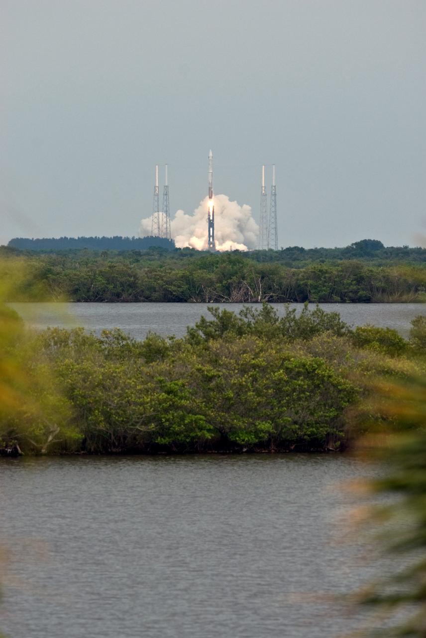 CAPE CANAVERAL, Fla. – Viewed across the Indian River Lagoon, the Atlas V/Centaur rocket carrying NASA's Lunar Reconnaissance Orbiter, or LRO, and NASA's Lunar Crater Observation and Sensing Satellite, known as LCROSS, lifts off from Launch Complex 41 at Cape Canaveral Air Force Station in Florida.  Surrounding the pad are lightning towers. LRO and LCROSS are the first missions in NASA's plan to return humans to the moon and begin establishing a lunar outpost by 2020. The LRO also includes seven instruments that will help NASA characterize the moon's surface:  DIVINER, LAMP, LEND, LOLA , CRATER, Mini-RF and LROC.   Launch was on-time at 5:32 p.m. EDT June 18.  Photo credit: NASA/Tony Gray