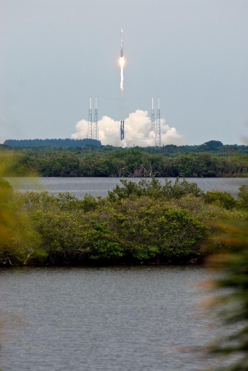 CAPE CANAVERAL, Fla. – Viewed across the Indian River Lagoon, the Atlas V/Centaur rocket carrying NASA's Lunar Reconnaissance Orbiter, or LRO, and NASA's Lunar Crater Observation and Sensing Satellite, known as LCROSS, trails a tail of smoke as it roars into the sky after launch from Launch Complex 41 at Cape Canaveral Air Force Station in Florida.  Surrounding the pad are lightning towers. LRO and LCROSS are the first missions in NASA's plan to return humans to the moon and begin establishing a lunar outpost by 2020. The LRO also includes seven instruments that will help NASA characterize the moon's surface:  DIVINER, LAMP, LEND, LOLA , CRATER, Mini-RF and LROC.   Launch was on-time at 5:32 p.m. EDT June 18.  Photo credit: NASA/Tony Gray