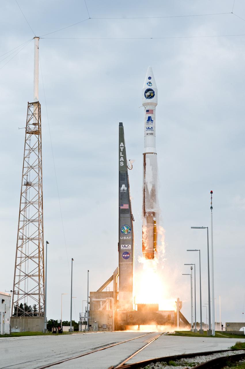 CAPE CANAVERAL, Fla. – The Atlas V/centaur rocket fires as it lifts NASA's Lunar Reconnaissance Orbiter, or LRO, and NASA's Lunar Crater Observation and Sensing Satellite, known as LCROSS, from Launch Complex 41 at Cape Canaveral Air Force Station in Florida. The tower at left is part of the lightning protection system on the pad. LRO and LCROSS are the first missions in NASA's plan to return humans to the moon and begin establishing a lunar outpost by 2020. The LRO also includes seven instruments that will help NASA characterize the moon's surface:  DIVINER, LAMP, LEND, LOLA , CRATER, Mini-RF and LROC.  Launch was on-time at 5:32 p.m. EDT.  Photo credit: NASA/Tom Farrar, Kevin O'Connell