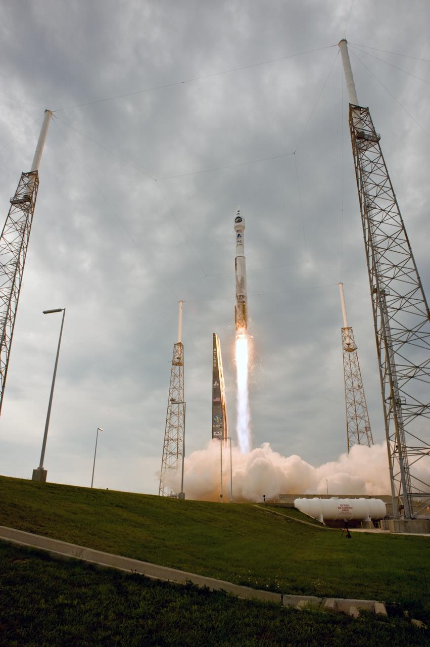 CAPE CANAVERAL, Fla. – Trailing a column of fire, the Atlas V/Centaur carrying NASA's Lunar Reconnaissance Orbiter, or LRO, and NASA's Lunar Crater Observation and Sensing Satellite, known as LCROSS, races above the lightning tower at left on Launch Complex 41 at Cape Canaveral Air Force Station in Florida.  The surrounding towers are part of the lightning protection system.    LRO and LCROSS are the first missions in NASA's plan to return humans to the moon and begin establishing a lunar outpost by 2020. The LRO also includes seven instruments that will help NASA characterize the moon's surface:  DIVINER, LAMP, LEND, LOLA , CRATER, Mini-RF and LROC.  Launch was on-time at 5:32 p.m. EDT.  Photo credit: NASA/Sandra Joseph, Tony Gray