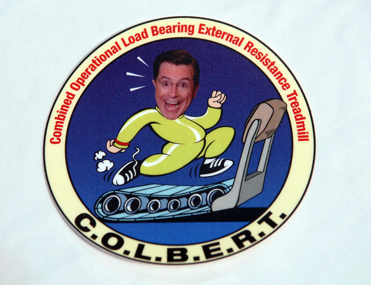 CAPE CANAVERAL, Fla. – This decal will be placed on the Combined Operational Load Bearing External Resistance Treadmill, or C.O.L.B.E.R.T., that will be carried to the International Space Station aboard space shuttle Discovery on the STS-128 mission.  The treadmill is in the Space Station Processing Facility at NASA's Kennedy Space Center in Florida and will be placed in the Leonardo multi-purpose logistics module with science and storage racks.  The treadmill is named after comedian Stephen Colbert, the host of Comedy Central’s “The Colbert Report.” Colbert urged his viewers to suggest the name “Colbert” as the name for the station’s Node 3 module. Although his name did receive the most entries in an Internet polling contest, NASA chose the name “Tranquility” to honor the accomplishments of the Apollo 11 mission. COLBERT will be installed in Tranquility after the node arrives at the station next year. Launch of STS-128 is targeted for Aug. 7, 2009.  Photo credit: NASA/Jim Grossmann
