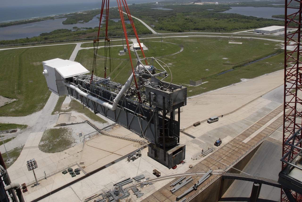 CAPE CANAVERAL, Fla. – The slings from a large crane swing the detached orbiter access arm, which ends in the White Room, away from the fixed service structure, or FSS, on Launch Pad 39B at NASA's Kennedy Space Center in Florida. The White Room provided entry into space shuttles that were on the pad. The arm is being removed from the FSS for the pad's conversion as launch site for the Constellation Program's Ares I-X. The launch of the Ares I-X flight test is targeted for August 2009. Photo credit: NASA/Kim Shiflett