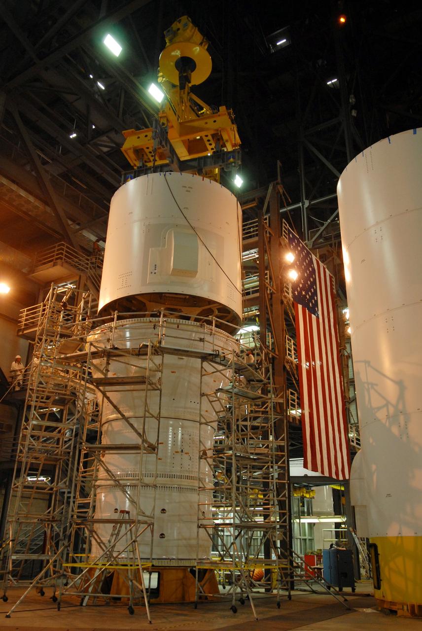 CAPE CANAVERAL, Fla. – In the Vehicle Assembly Building's High Bay 4 at NASA's Kennedy Space Center in Florida, the Ares I-X interstage 1 for the upper stage simulator is  lowered onto the forward assembly.  It will be mated with the frustum on top of the forward assembly.  Ares I-X is the flight test vehicle for the Ares I, a component of the Constellation Program. Ares I is the essential core of a safe, reliable, cost-effective space transportation system that eventually will carry crewed missions back to the moon, on to Mars and out into the solar system.  Ares I-X is targeted for launch in August 2009.  Photo credit: NASA/Tim Jacobs