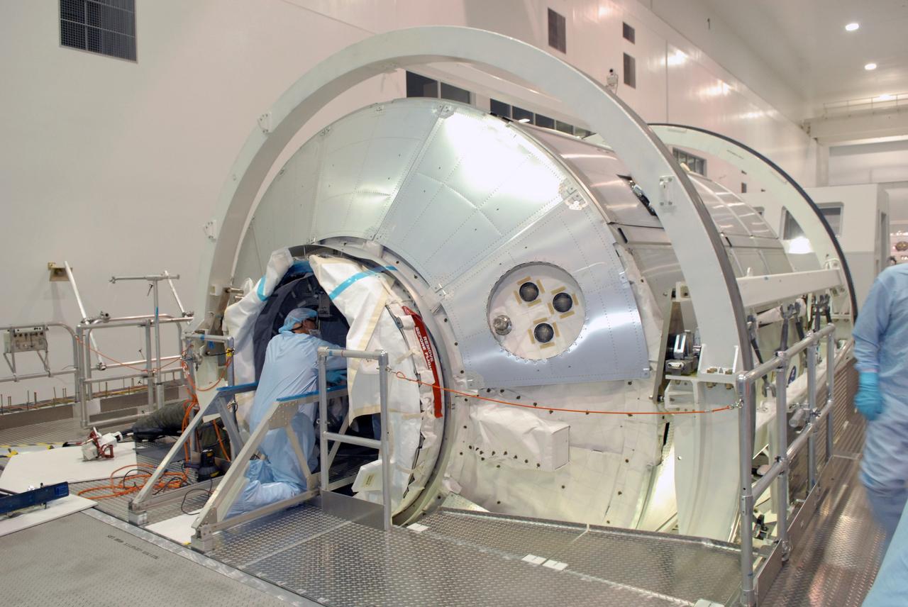 CAPE CANAVERAL, Fla. – In the Space Station Processing Facility at NASA's Kennedy Space Center in Florida, workers prepare the opening in the Multi-Purpose Logistics Module Leonardo for hatch closure. The module will carry science and storage racks on space shuttle Discovery's STS-128 mission to the International Space Station.  Launch of Discovery is targeted for Aug. 18.  Photo credit: NASA/Jim Grossmann