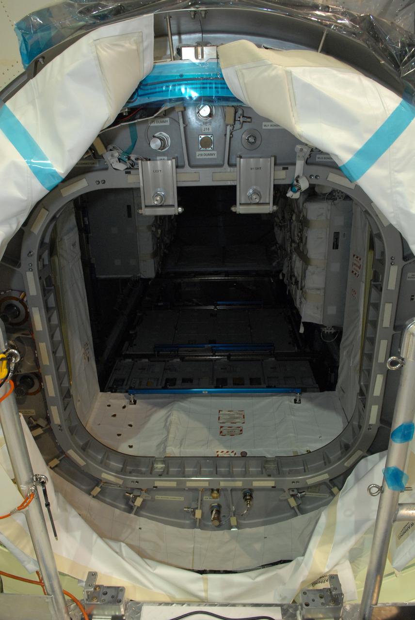CAPE CANAVERAL, Fla. – In the Space Station Processing Facility at NASA's Kennedy Space Center in Florida, the opening in the Multi-Purpose Logistics Module Leonardo reveals part of the payload.  The module is being prepared for hatch closure. The module is being prepared for hatch closure. The module will carry science and storage racks on space shuttle Discovery's STS-128 mission to the International Space Station.  Launch of Discovery is targeted for Aug. 18.  Photo credit: NASA/Jim Grossmann