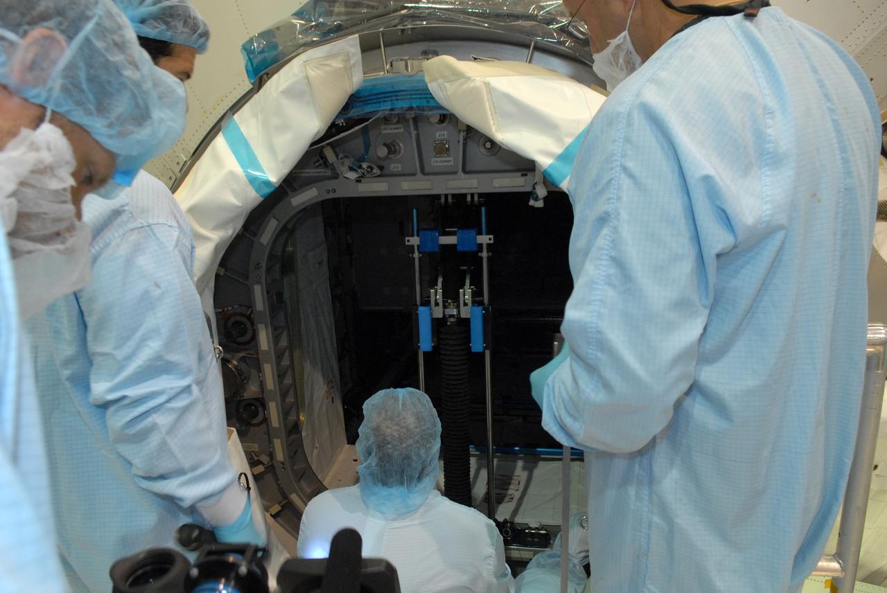 CAPE CANAVERAL, Fla. – In the Space Station Processing Facility at NASA's Kennedy Space Center in Florida, workers begin closing the hatch to the Multi-Purpose Logistics Module Leonardo.  The module will carry science and storage racks on space shuttle Discovery's STS-128 mission to the International Space Station.  Launch of Discovery is targeted for Aug. 18.  Photo credit: NASA/Jim Grossmann