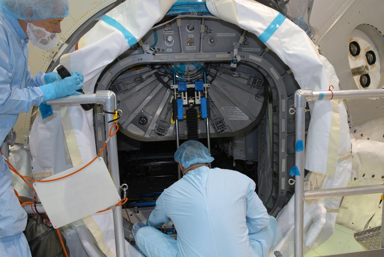 CAPE CANAVERAL, Fla. – In the Space Station Processing Facility at NASA's Kennedy Space Center in Florida, workers close the hatch to the Multi-Purpose Logistics Module Leonardo.  The module will carry science and storage racks on space shuttle Discovery's STS-128 mission to the International Space Station.  Launch of Discovery is targeted for Aug. 18.  Photo credit: NASA/Jim Grossmann