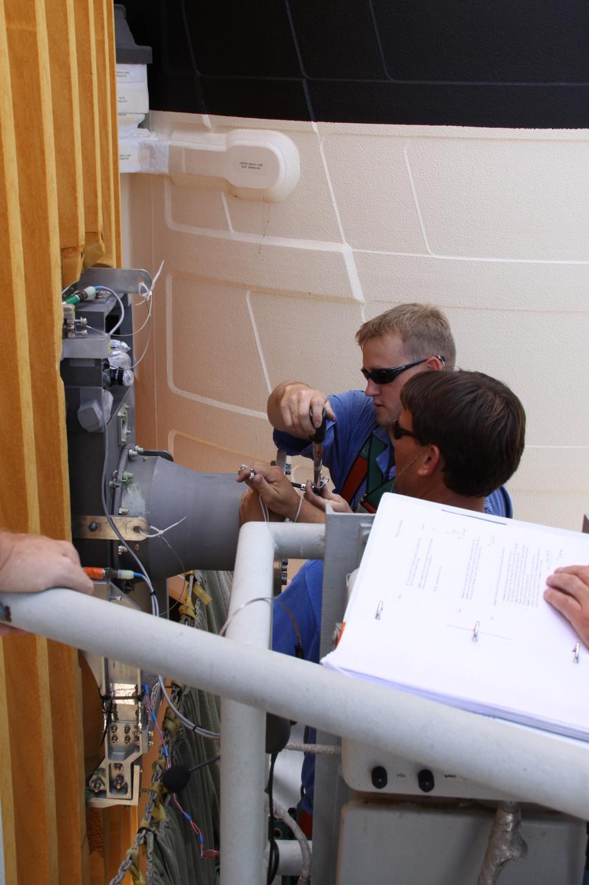 CAPE CANAVERAL, Fla. – On Launch Pad 39A at NASA's Kennedy Space Center in Florida, workers remove the  7-inch quick disconnect on the Ground Umbilical Carrier Plate, or GUCP, on space shuttle Endeavour's external fuel tank. A hydrogen leak at the location during tanking for the STS-127 mission caused the launch attempts to be scrubbed on June 13 and June 17. The GUCP will be examined to determine the cause of the hydrogen leak and repaired. The GUCP is the overboard vent to the pad and the flame stack where the vented hydrogen is burned off. Endeavour's next launch attempt is targeted for July 11 at 7:39 p.m. EDT. Photo credit: NASA/Jack Pfaller