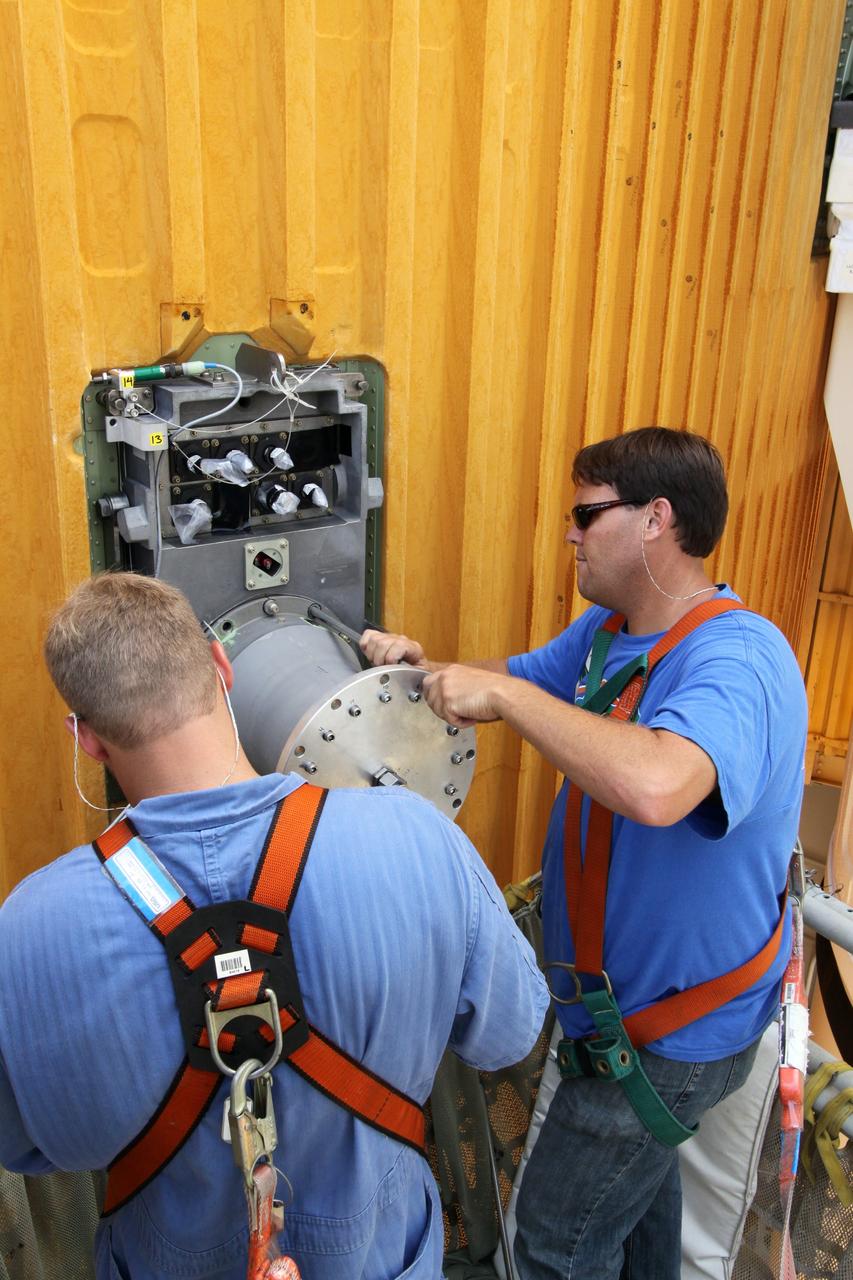 CAPE CANAVERAL, Fla. – On Launch Pad 39A at NASA's Kennedy Space Center in Florida, workers remove the  7-inch quick disconnect on the Ground Umbilical Carrier Plate, or GUCP, on space shuttle Endeavour's external fuel tank. A hydrogen leak at the location during tanking for the STS-127 mission caused the launch attempts to be scrubbed on June 13 and June 17. The GUCP will be examined to determine the cause of the hydrogen leak and repaired. The GUCP is the overboard vent to the pad and the flame stack where the vented hydrogen is burned off. Endeavour's next launch attempt is targeted for July 11 at 7:39 p.m. EDT. Photo credit: NASA/Jack Pfaller