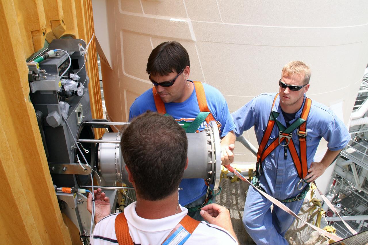 CAPE CANAVERAL, Fla. – On Launch Pad 39A at NASA's Kennedy Space Center in Florida,  a worker has removed the 7-inch quick disconnect from the Ground Umbilical Carrier Plate, or GUCP, on space shuttle Endeavour's external fuel tank. A hydrogen leak at the location during tanking for the STS-127 mission caused the launch attempts to be scrubbed on June 13 and June 17. The GUCP will be examined to determine the cause of the hydrogen leak and repaired. The GUCP is the overboard vent to the pad and the flame stack where the vented hydrogen is burned off. Endeavour's next launch attempt is targeted for July 11 at 7:39 p.m. EDT. Photo credit: NASA/Jack Pfaller