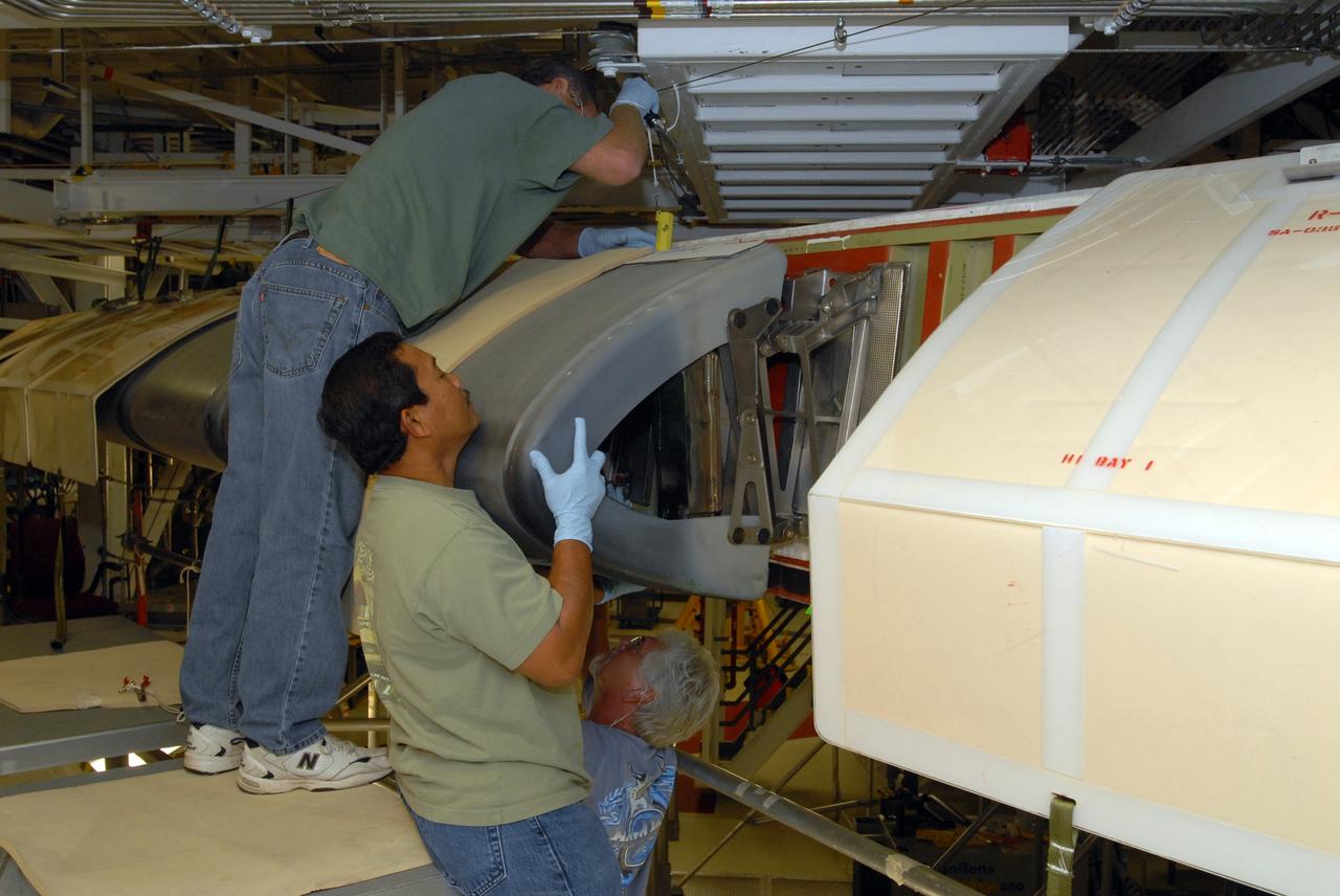CAPE CANAVERAL, Fla. – In Orbiter Processing Facility 1 at NASA's Kennedy Space Center in Florida, workers remove the reinforced-carbon carbon, or RCC, panels from the wing leading edge on space shuttle Atlantis. The structural edge of the wing (area of red and green behind the panels) will undergo spar corrosion inspection to verify the structural integrity of the wing. The RCC panels will be placed in protective coverings until the inspection is complete. Atlantis will make the 31st flight to the International Space Station for the STS-129 mission, targeted for launch on Nov. 12. Photo credit: NASA/Tim Jacobs