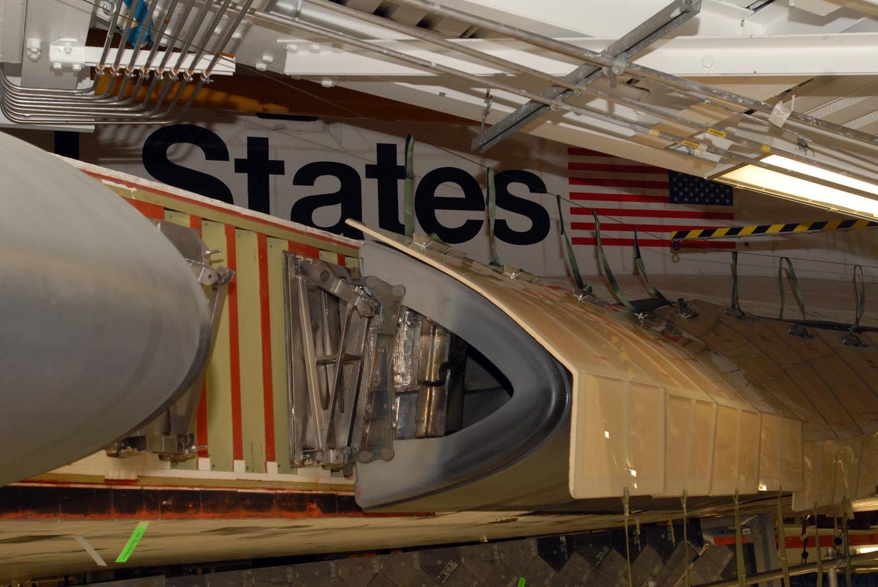 CAPE CANAVERAL, Fla. – A closeup of the wing leading edge on space shuttle Atlantis where a reinforced-carbon carbon, or RCC, panel has been removed. The structural edge of the wing (area of red and green behind the panels) will undergo spar corrosion inspection to verify the structural integrity of the wing.  The RCC panels will be placed in protective coverings until the inspection is complete.  Atlantis will make the 31st flight to the International Space Station for the STS-129 mission, targeted for launch on Nov. 12. Photo credit: NASA/Tim Jacobs