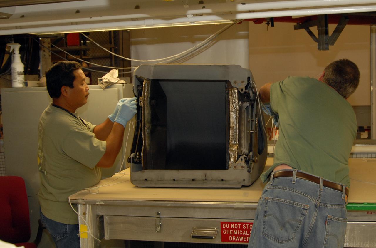 CAPE CANAVERAL, Fla. – In Orbiter Processing Facility 1 at NASA's Kennedy Space Center in Florida, workers place a protective cover over a reinforced-carbon carbon, or RCC, panel removed from space shuttle Atlantis. for SPAR corrosion inspection. The structural edge of the wing will undergo spar corrosion inspection to verify the structural integrity of the wing. The RCC panels will be placed in protective coverings until the inspection is complete. Atlantis will make the 31st flight to the International Space Station for the STS-129 mission, targeted for launch on Nov. 12. Photo credit: NASA/Tim Jacobs