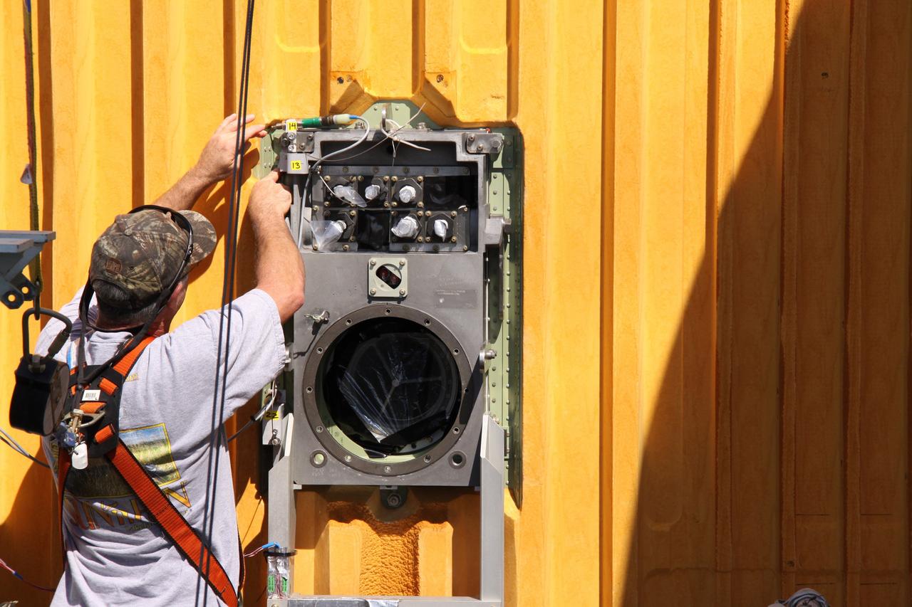 CAPE CANAVERAL, Fla. – On Launch Pad 39A at NASA's Kennedy Space Center in Florida, workers prepare to remove the seal from the Ground Umbilical Carrier Plate, or GUCP, on space shuttle Endeavour's external fuel tank.  A hydrogen leak at the location during tanking for the STS-127 mission caused the launch attempts to be scrubbed on June 13 and June 17. The GUCP will be examined to determine the cause of the hydrogen leak and repaired. The GUCP is the overboard vent to the pad and the flame stack where the vented hydrogen is burned off. Endeavour's next launch attempt is targeted for July 11 at 7:39 p.m. EDT. Photo credit: NASA/Jack Pfaller
