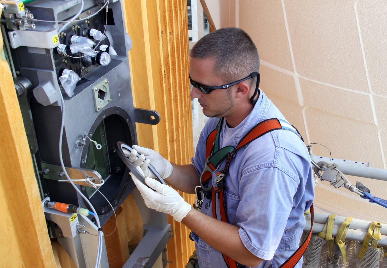 CAPE CANAVERAL, Fla. – On Launch Pad 39A at NASA's Kennedy Space Center in Florida, a worker has removed the seal from the Ground Umbilical Carrier Plate, or GUCP, on space shuttle Endeavour's external fuel tank.  A hydrogen leak at the location during tanking for the STS-127 mission caused the launch attempts to be scrubbed on June 13 and June 17. The GUCP will be examined to determine the cause of the hydrogen leak and repaired. The GUCP is the overboard vent to the pad and the flame stack where the vented hydrogen is burned off. Endeavour's next launch attempt is targeted for July 11 at 7:39 p.m. EDT. Photo credit: NASA/Jack Pfaller