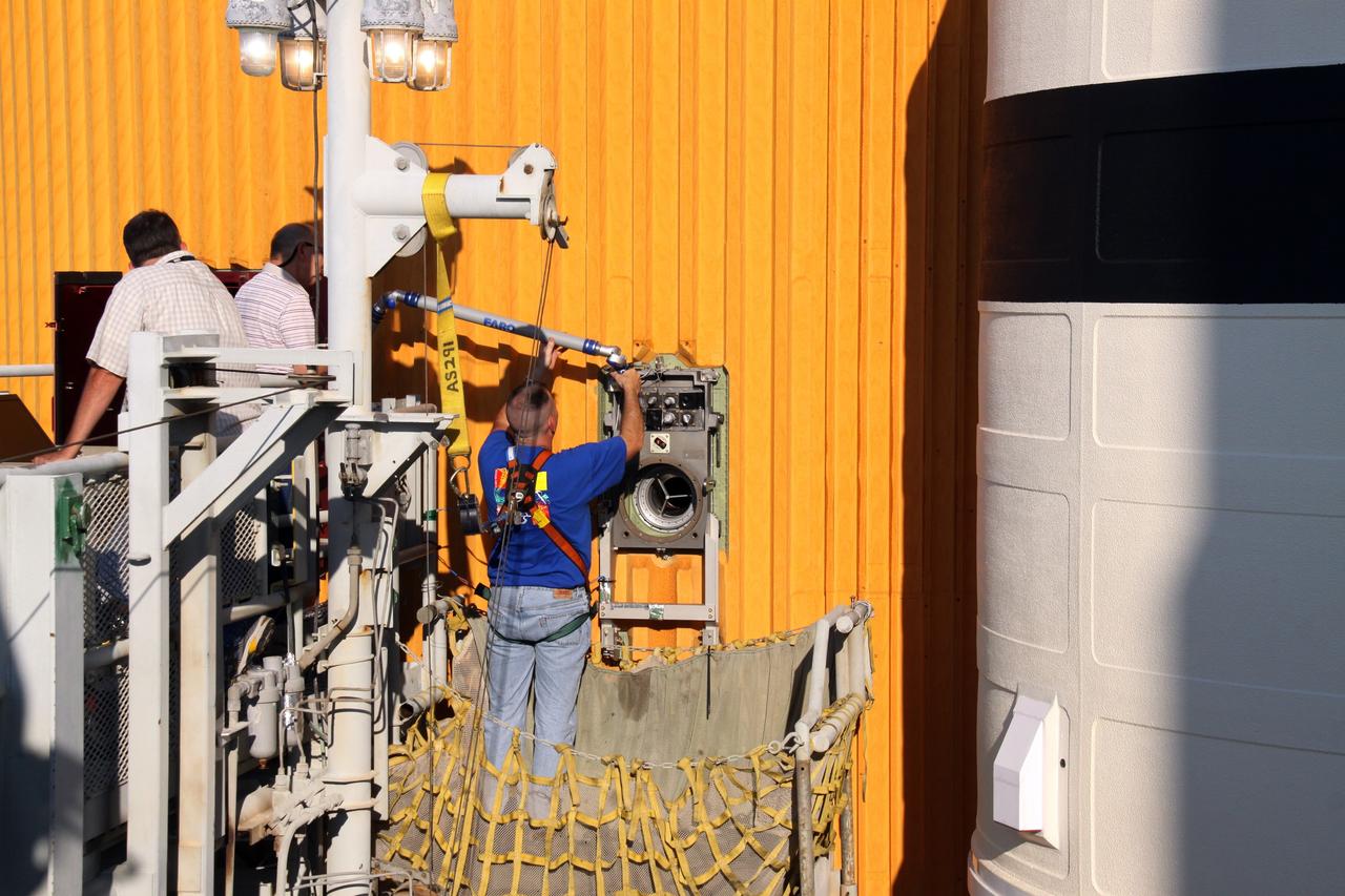 CAPE CANAVERAL, Fla. – On Launch Pad 39A at NASA's Kennedy Space Center in Florida, work continues on removing the Ground Umbilical Carrier Plate, or GUCP, on space shuttle Endeavour's external fuel tank.  A hydrogen leak at the location during tanking for the STS-127 mission caused the launch attempts to be scrubbed on June 13 and June 17. The GUCP will be examined to determine the cause of the hydrogen leak and repaired. The GUCP is the overboard vent to the pad and the flame stack where the vented hydrogen is burned off. Endeavour's next launch attempt is targeted for July 11 at 7:39 p.m. EDT. Photo credit: NASA/Jack Pfaller
