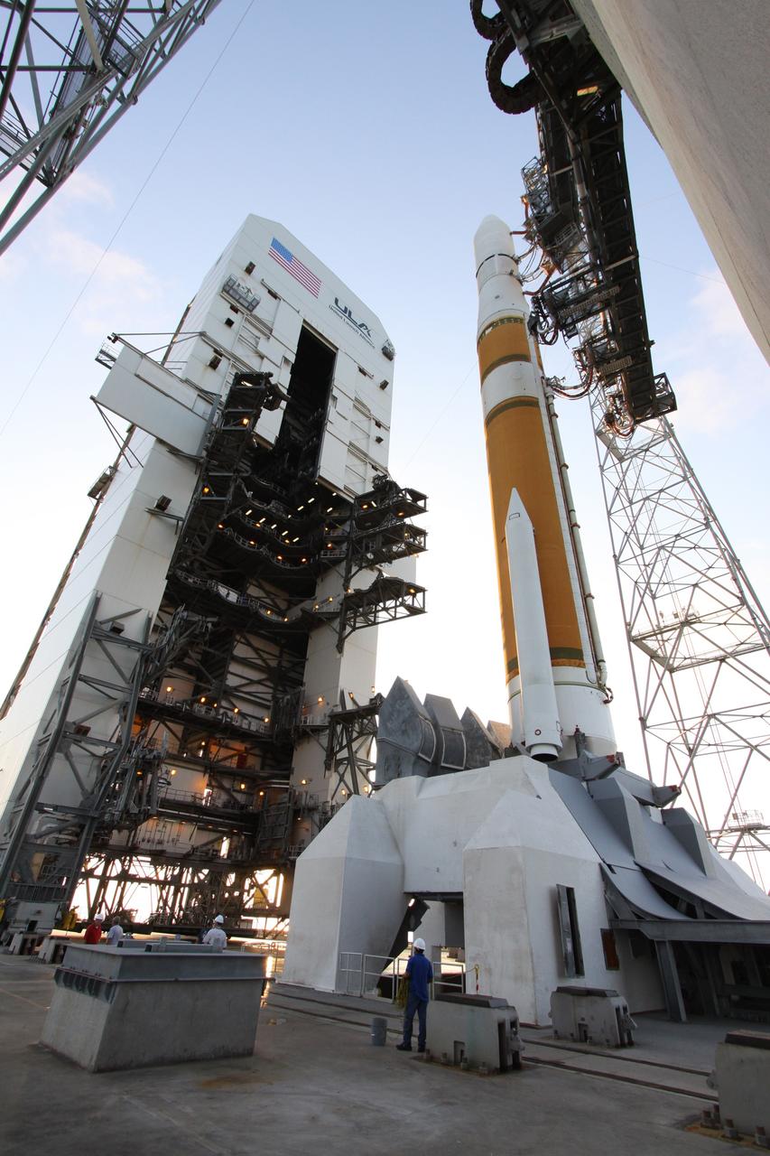 CAPE CANAVERAL, Fla. – Workers on Launch Complex 37 at Cape Canaveral Air Force Station monitor the movement of the mobile service tower as it slowly rolls away from the Boeing Delta IV rocket that will launch the GOES-O satellite into orbit.  The terminal countdown to the liftoff of GOES-O will begin at 12:59 p.m. EDT for a launch window that extends from 6:14 p.m. to 7:14 p.m. June 26. The latest Geostationary Operational Environmental Satellite, GOES-O was developed by NASA for the National Oceanic and Atmospheric Administration, or NOAA. Each of the GOES satellites continuously provides observations of 60 percent of the Earth including the continental United States, providing weather monitoring and forecast operations as well as a continuous and reliable stream of environmental information and severe weather warnings. Once in orbit, GOES-O will be designated GOES-14, and NASA will provide on-orbit checkout and then transfer operational responsibility to NOAA.  Photo credit: NASA/Jack Pfaller
