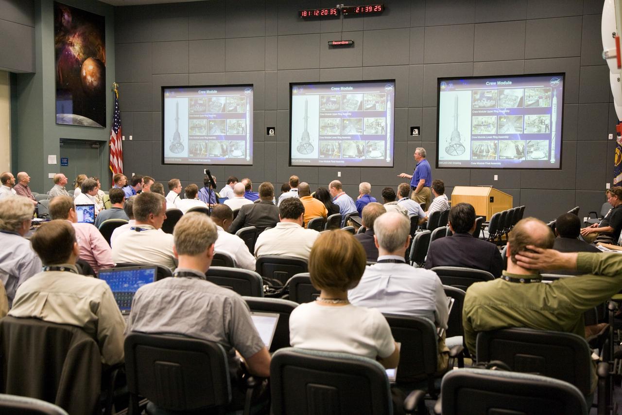 CAPE CANAVERAL, Fla. – At NASA's Kennedy Space Center in Florida, the Ares I-X management team reviews consensus for stacking and mating of the I-X upper stage segments. Steve Davis, deputy mission manager, provides a slide presentation of the Crew Module. Launch of the Ares I-X flight test is targeted no earlier than Aug. 30 from Launch Pad 39B. Ares I is the essential core of a safe, reliable, cost-effective space transportation system that eventually will carry crewed missions back to the moon, on to Mars and out into the solar system. Photo credit: NASA/Dimitri Gerondidakis