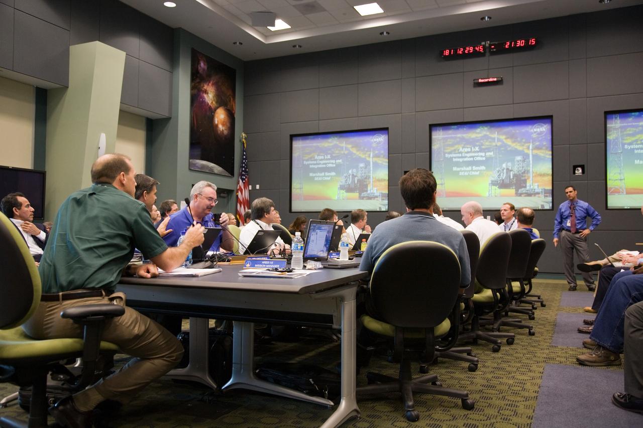 CAPE CANAVERAL, Fla. – At NASA's Kennedy Space Center in Florida, Marshall Smith, the Ares I-X Systems Engineering and Integration chief, reviews consensus for stacking and mating of the I-X upper stage segments with the management team. Launch of the Ares I-X flight test is targeted no earlier than Aug. 30 from Launch Pad 39B. Ares I is the essential core of a safe, reliable, cost-effective space transportation system that eventually will carry crewed missions back to the moon, on to Mars and out into the solar system. Photo credit: NASA/Dimitri Gerondidakis