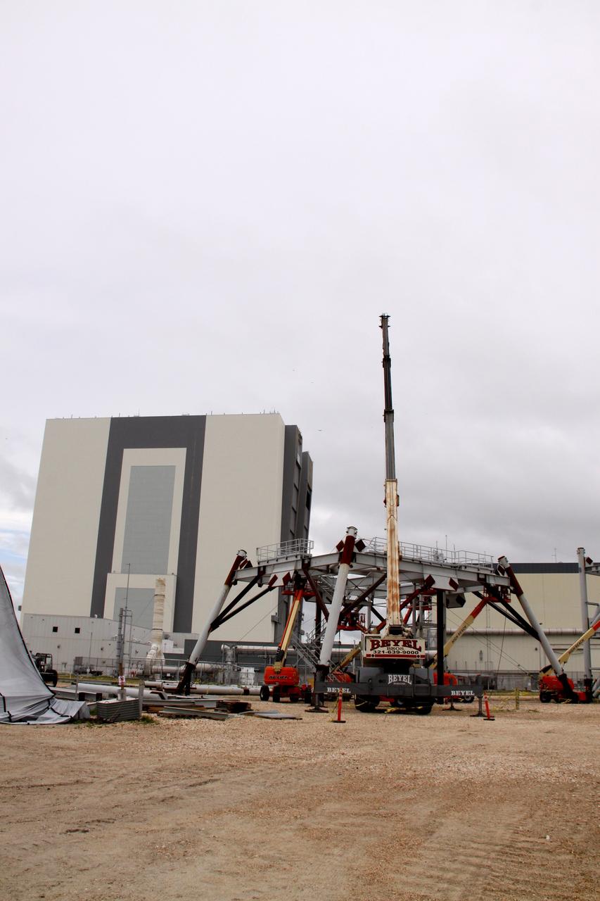 CAPE CANAVERAL, Fla. – At At NASA's Kennedy Space Center in Florida, construction is under way on a new mobile launcher for the Constellation Program.  The mobile launcher park site is behind the Vehicle Assembly Building (in the background). The new mobile launcher will be the base for the Ares rockets to launch the Orion crew exploration vehicle and the cargo vehicle.  The base is being made lighter than space shuttle mobile launcher platforms so the crawler-transporter can pick up the added load of the 345-foot tower and taller rocket.  When the structural portion of the new launcher is complete, umbilical lines, access arms, communications equipment and command/control equipment will be installed.  Photo credit:  Photo credit: NASA/Jack Pfaller