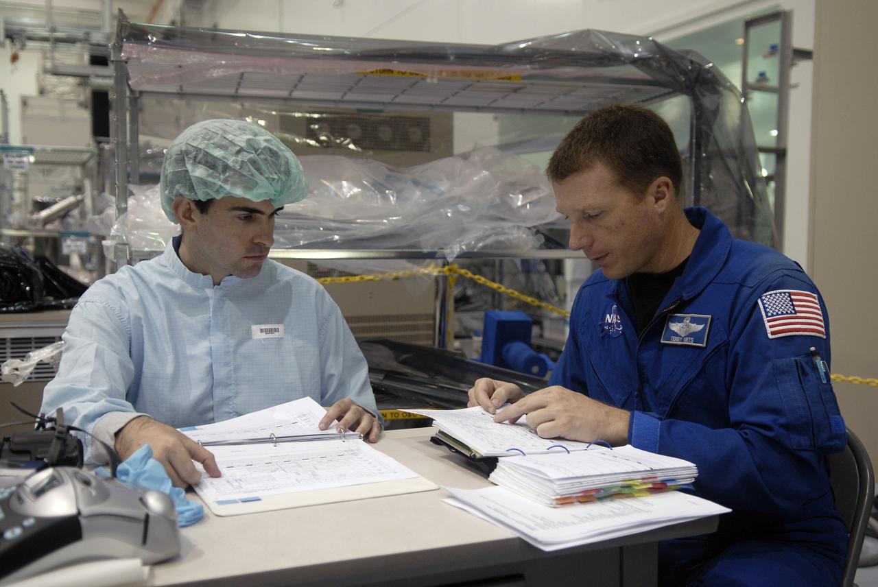 CAPE CANAVERAL, Fla. – In the Space Station Processing Facility at NASA's Kennedy Space Center in Florida, STS-130 Pilot Terry Virts (right) reviews information about the Cupola, part of space shuttle Endeavour's  payload on the mission to the International Space Station. Crew members are at Kennedy for familiarization with mission equipment and hardware, called the crew equipment interface test. The payload on the 32nd assembly flight to the International Space Station also includes the Tranquility Node 3. Cupola will provide a 360-degree panoramic view of activities outside the station and spectacular views of the Earth.  Cupola has the capability for command and control workstations to be installed to assist in the space station remote manipulator system and extra vehicular activities. The final element of the space station core, Cupola is targeted for launch Feb. 4, 2010.   Photo credit: NASA/Kim Shiflett
