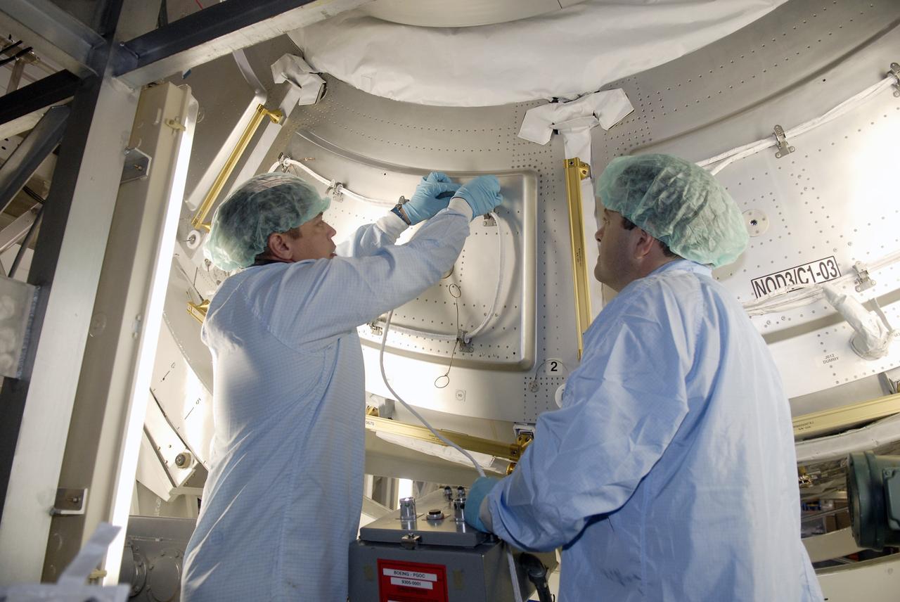 CAPE CANAVERAL, Fla. – In the Space Station Processing Facility at NASA's Kennedy Space Center in Florida, STS-130 Mission Specialist Robert Behnken  (left) practices working on the Cupola, part of space shuttle Endeavour's  payload on the mission to the International Space Station.  At right is Mission Specialist Nicholas Patrick.  Crew members are at Kennedy for familiarization with mission equipment and hardware, called the crew equipment interface test.  The payload on the 32nd assembly flight to the International Space Station also includes the Tranquility Node 3. Cupola will provide a 360-degree panoramic view of activities outside the station and spectacular views of the Earth.  Cupola has the capability for command and control workstations to be installed to assist in the space station remote manipulator system and extra vehicular activities. The final element of the space station core, Cupola is targeted for launch Feb. 4, 2010.   Photo credit: NASA/Kim Shiflett