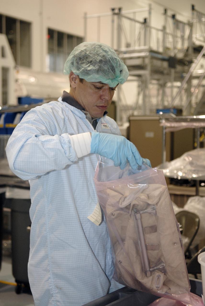 CAPE CANAVERAL, Fla. – In the Space Station Processing Facility at NASA's Kennedy Space Center in Florida, STS-130 Mission Specialist Robert Behnken becomes familiar with equipment that will be on the mission. Crew members are at Kennedy for familiarization with mission equipment and hardware, called the crew equipment interface test. The payload on the 32nd assembly flight to the International Space Station includes the Cupola and the Tranquility Node 3. Cupola will provide a 360-degree panoramic view of activities outside the station and spectacular views of the Earth. Cupola has the capability for command and control workstations to be installed to assist in the space station remote manipulator system and extra vehicular activities. The final element of the space station core, Cupola is targeted for launch Feb. 4, 2010. Photo credit: NASA/Kim Shiflett