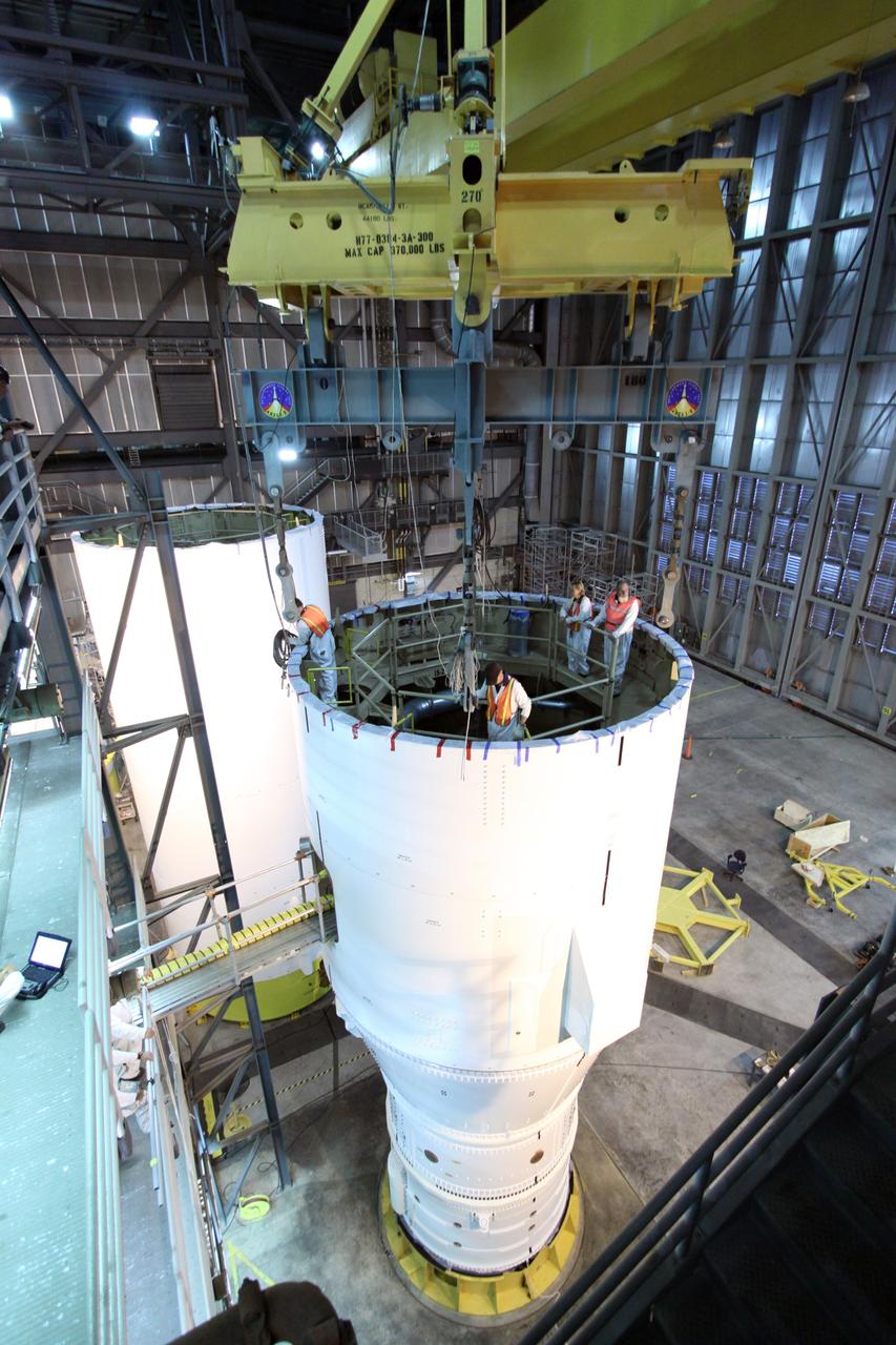 CAPE CANAVERAL, Fla. – In the Vehicle Assembly Building at NASA's Kennedy Space Center in Florida, the segments of the Ares I-X first stage are fitted with a crane to lift it to the fifth segment simulator for mating,  completing  Super Stack 1.  The super stack comprises the forward skirt, forward skirt extension, interstages 1 and 2 and the fifth segment simulator. Ares I-X is the test vehicle for the Ares I, which is part of the Constellation Program to return men to the moon and beyond.  The Ares I-X flight test is targeted no earlier than Aug. 30 from Launch Pad 39B.  Photo credit: NASA/Jack Pfaller
