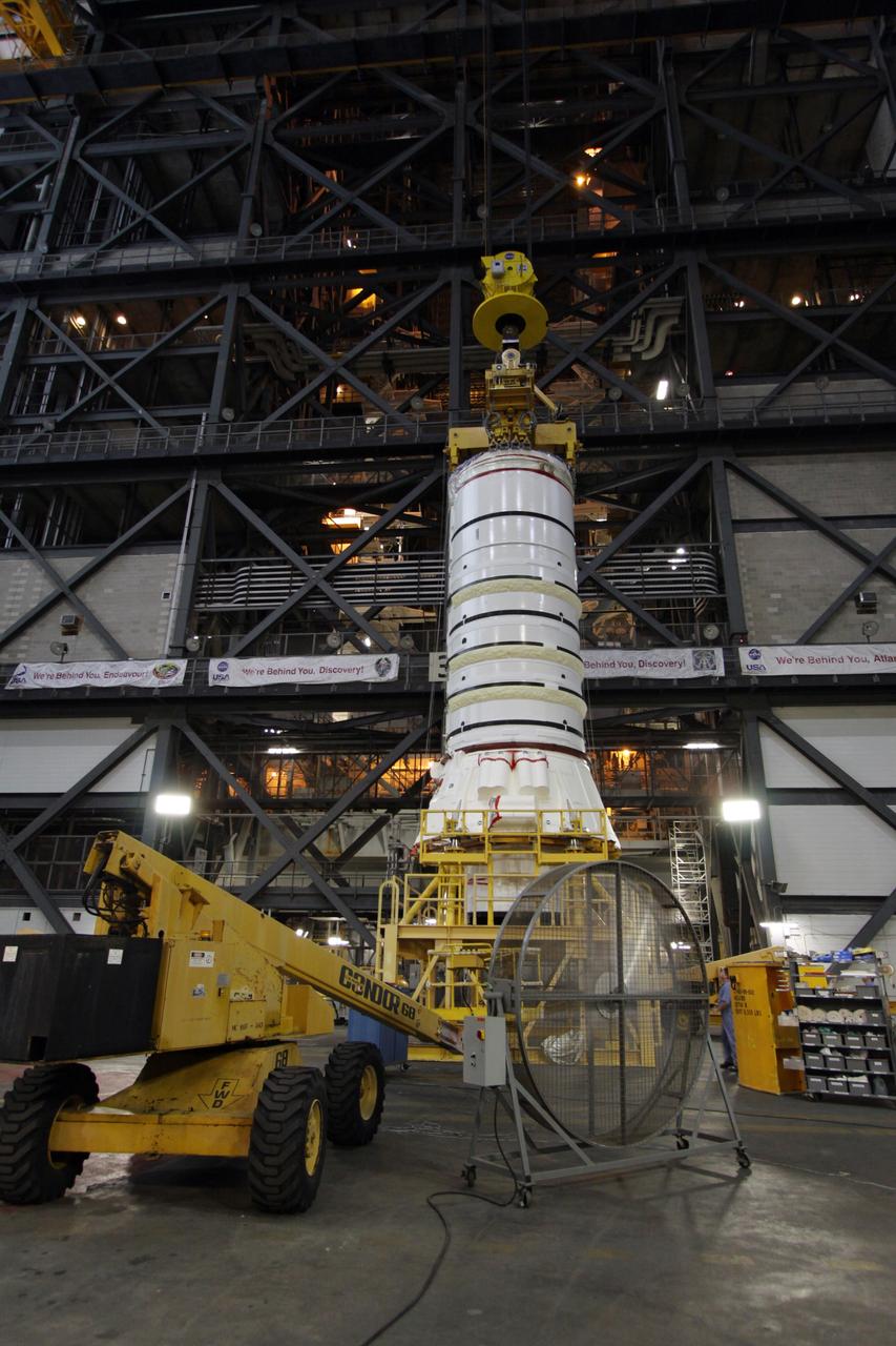CAPE CANAVERAL, Fla. – In the Vehicle Assembly Building at NASA's Kennedy Space Center in Florida, the Ares I-X aft booster segment with the aft skirt is lifted from its stand. The stack will be hoisted into the upper regions of the VAB and lowered onto the mobile launch platform in High Bay 3. This is the start of the buildup of the Ares I-X launch vehicle for the flight test targeted for no earlier than Aug. 30. Part of the Constellation Program, the Ares I-X is the test vehicle for the Ares I, which is the essential core of a space transportation system that eventually will carry crewed missions back to the moon, on to Mars and out into the solar system. Photo credit: NASA/Jack Pfaller