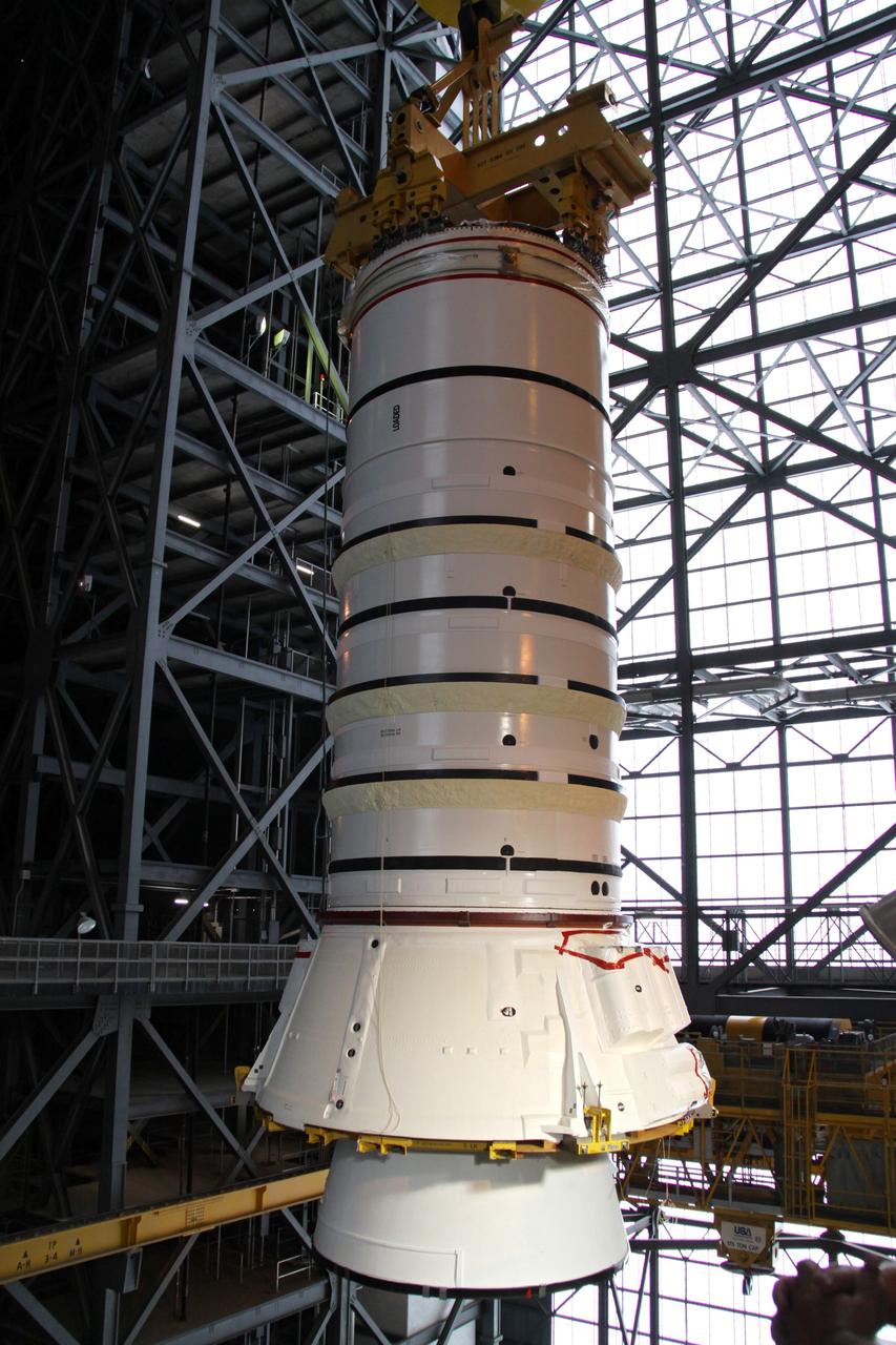 CAPE CANAVERAL, Fla. – In the Vehicle Assembly Building at NASA's Kennedy Space Center in Florida, the Ares I-X aft booster segment with the aft skirt is lifted into the upper regions of the VAB. The stack will be lowered onto the mobile launch platform in High Bay 3. This is the start of the buildup of the Ares I-X launch vehicle for the flight test targeted for no earlier than Aug. 30. Part of the Constellation Program, the Ares I-X is the test vehicle for the Ares I, which is the essential core of a space transportation system that eventually will carry crewed missions back to the moon, on to Mars and out into the solar system. Photo credit: NASA/Jack Pfaller
