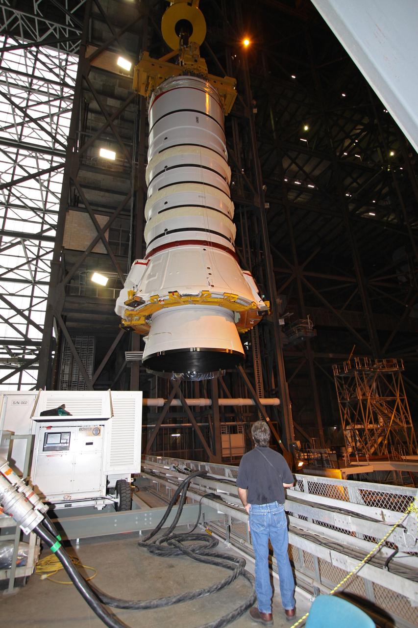 CAPE CANAVERAL, Fla. – In the Vehicle Assembly Building at NASA's Kennedy Space Center in Florida, the Ares I-X aft booster segment with the aft skirt is moved to High Bay 1 where it will be lowered onto the mobile launch platform in High Bay 3. This is the start of the buildup of the Ares I-X launch vehicle for the flight test targeted for no earlier than Aug. 30. Part of the Constellation Program, the Ares I-X is the test vehicle for the Ares I, which is the essential core of a space transportation system that eventually will carry crewed missions back to the moon, on to Mars and out into the solar system. Photo credit: NASA/Jack Pfaller
