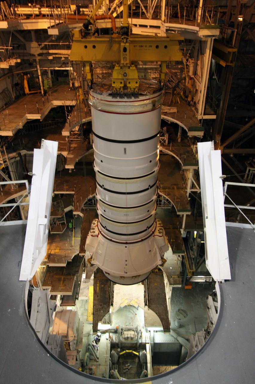 CAPE CANAVERAL, Fla. – In the Vehicle Assembly Building at NASA's Kennedy Space Center in Florida, the Ares I-X aft booster segment with the aft skirt is lowered into High Bay 3. It will be placed on the mobile launch platform. This is the start of the buildup of the Ares I-X launch vehicle for the flight test targeted for no earlier than Aug. 30. Part of the Constellation Program, the Ares I-X is the test vehicle for the Ares I, which is the essential core of a space transportation system that eventually will carry crewed missions back to the moon, on to Mars and out into the solar system. Photo credit: NASA/Jack Pfaller