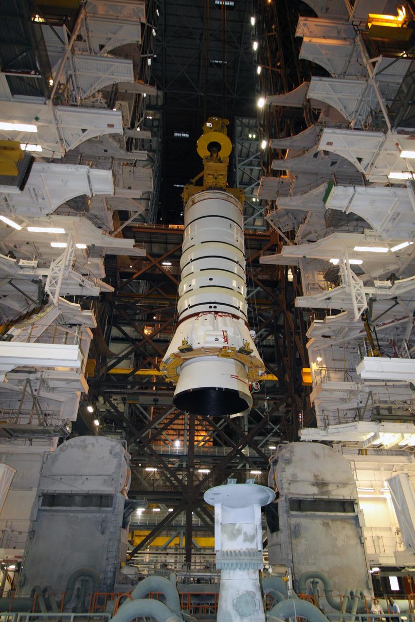 CAPE CANAVERAL, Fla. – In the Vehicle Assembly Building at NASA's Kennedy Space Center in Florida, the Ares I-X aft booster segment with the aft skirt is lowered toward the mobile launch platform in High Bay 3. This is the start of the buildup of the Ares I-X launch vehicle for the flight test targeted for no earlier than Aug. 30. Part of the Constellation Program, the Ares I-X is the test vehicle for the Ares I, which is the essential core of a space transportation system that eventually will carry crewed missions back to the moon, on to Mars and out into the solar system. Photo credit: NASA/Jack Pfaller