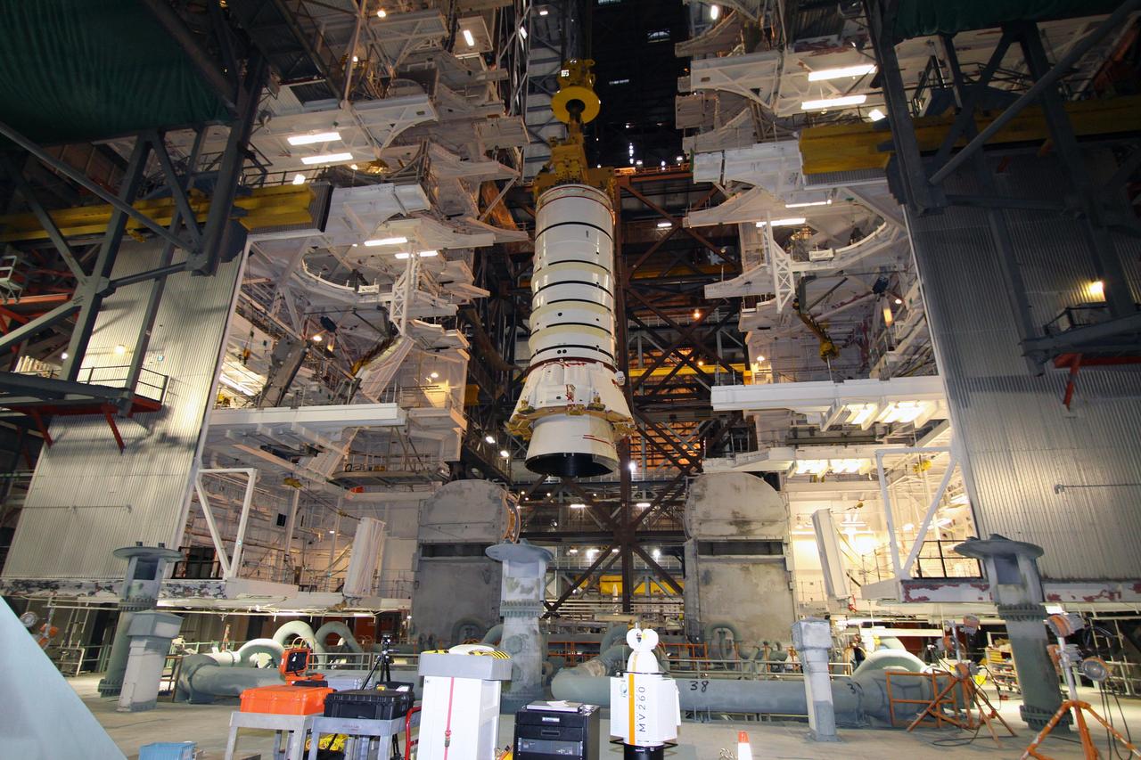 CAPE CANAVERAL, Fla. – In the Vehicle Assembly Building at NASA's Kennedy Space Center in Florida, the Ares I-X aft booster segment with the aft skirt is lowered toward the mobile launch platform in High Bay 3. This is the start of the buildup of the Ares I-X launch vehicle for the flight test targeted for no earlier than Aug. 30. Part of the Constellation Program, the Ares I-X is the test vehicle for the Ares I, which is the essential core of a space transportation system that eventually will carry crewed missions back to the moon, on to Mars and out into the solar system. Photo credit: NASA/Jack Pfaller