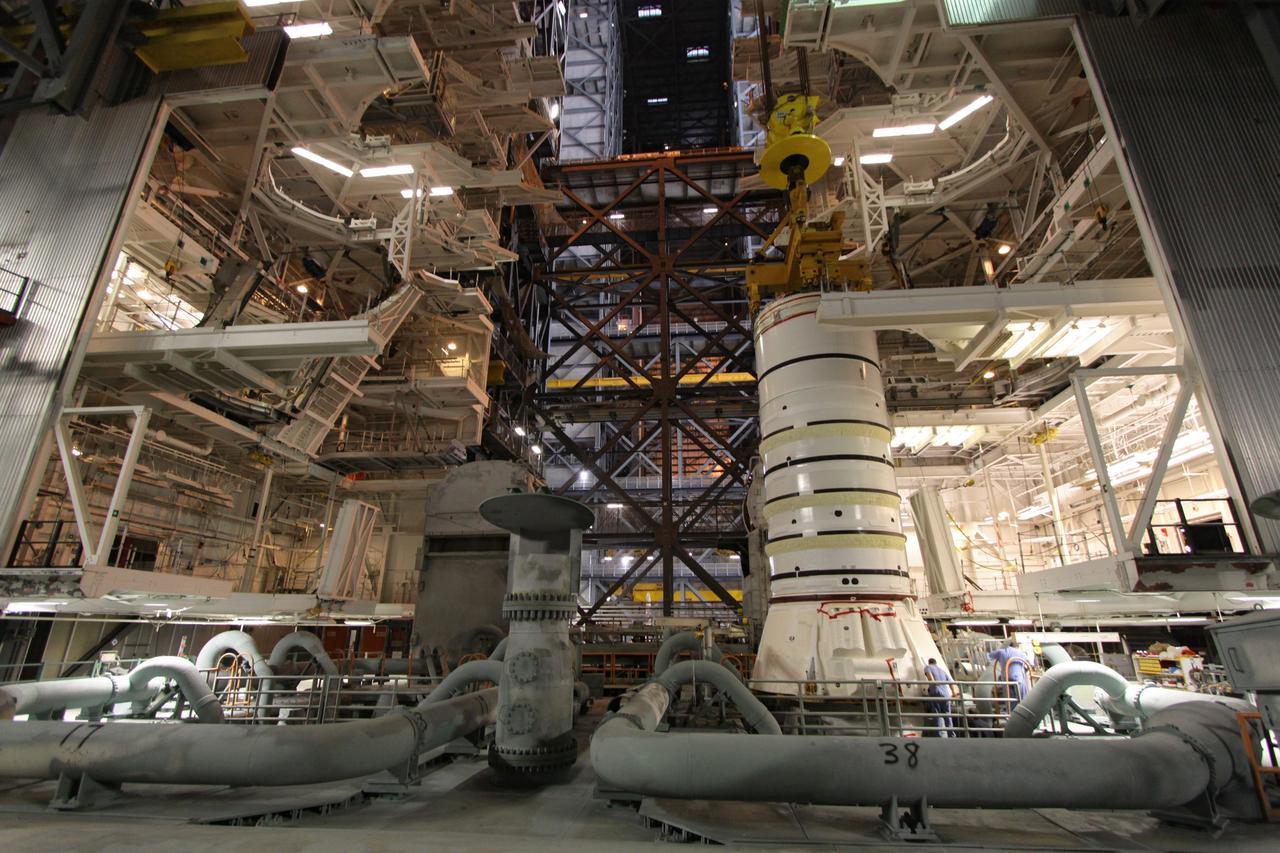 CAPE CANAVERAL, Fla. – In the Vehicle Assembly Building at NASA's Kennedy Space Center in Florida, the Ares I-X aft booster segment with the aft skirt is lowered onto the mobile launch platform in High Bay 3. This is the start of the buildup of the Ares I-X launch vehicle for the flight test targeted for no earlier than Aug. 30. Part of the Constellation Program, the Ares I-X is the test vehicle for the Ares I, which is the essential core of a space transportation system that eventually will carry crewed missions back to the moon, on to Mars and out into the solar system. Photo credit: NASA/Jack Pfaller