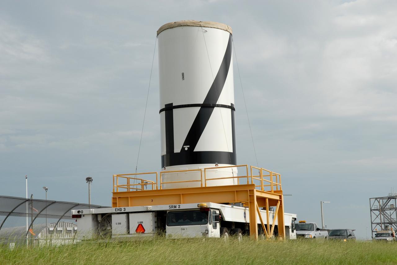 CAPE CANAVERAL, Fla. – The Ares I-X aft center booster segment is transported from the Rotation, Processing and Surge Facility to the Vehicle Assembly Building at NASA's Kennedy Space Center in Florida. The Ares I-X launch vehicle segments are being stacked in the VAB. Part of the Constellation Program, the Ares I-X is the test vehicle for the Ares I, which is the essential core of a space transportation system that eventually will carry crewed missions back to the moon, on to Mars and out into the solar system. Launch is targeted for no earlier than Aug. 30 from Launch Pad 39B. Photo credit: NASA/Jim Grossmann