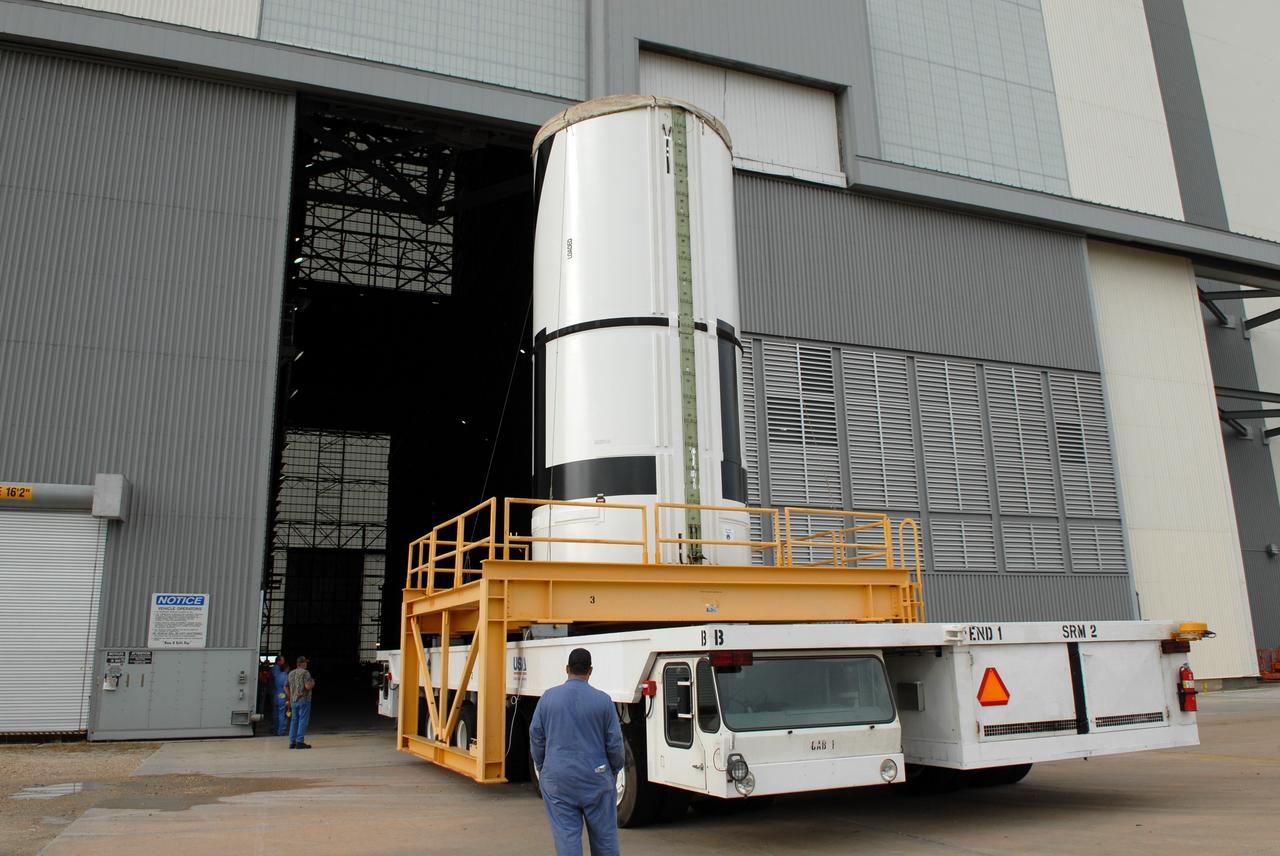 CAPE CANAVERAL, Fla. – The Ares I-X aft center booster segment rolls toward the open door of the Vehicle Assembly Building at NASA's Kennedy Space Center in Florida. The Ares I-X launch vehicle segments are being stacked in the VAB. Part of the Constellation Program, the Ares I-X is the test vehicle for the Ares I, which is the essential core of a space transportation system that eventually will carry crewed missions back to the moon, on to Mars and out into the solar system. Launch is targeted for no earlier than Aug. 30 from Launch Pad 39B. Photo credit: NASA/Jim Grossmann