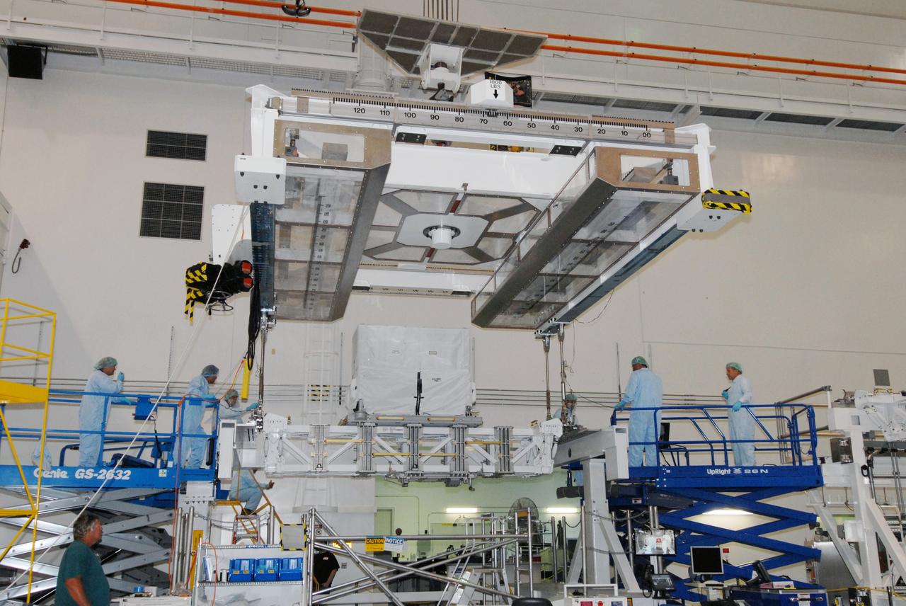 CAPE CANAVERAL, Fla. – In the Space Station Processing Facility at NASA's Kennedy Space Center in Florida, workers attach an overhead crane to the Lightweight Multi-Purpose Experiment Support Structure Carrier, or LMC, which holds an ammonia tank assembly. Part of the payload for space shuttle Discovery's STS-128 mission to the International Space Station, the carrier will be weighed and then installed in the payload canister. The STS-128 flight also will carry science and storage racks to the space station on Discovery. Launch of Discovery is targeted for Aug. 18. Photo credit: NASA/Tim Jacobs