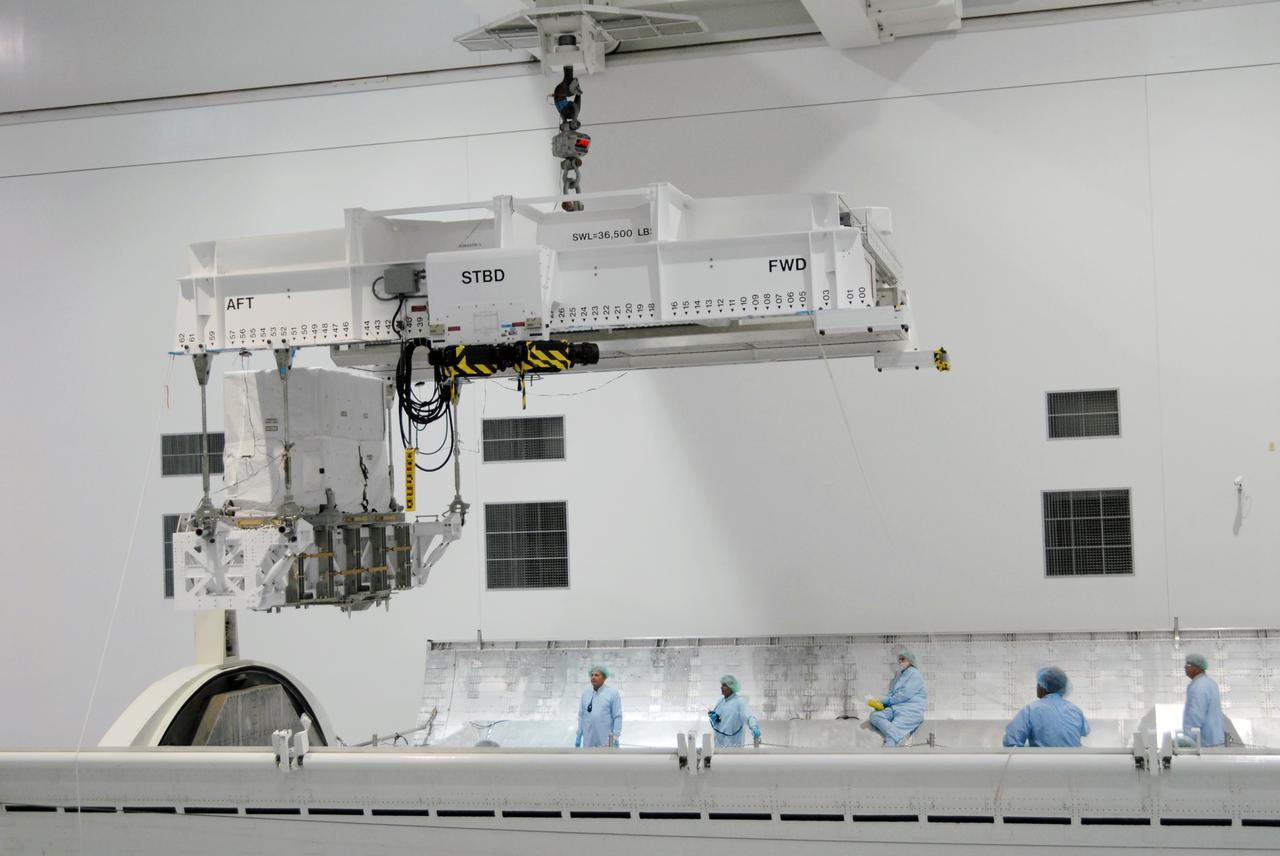 CAPE CANAVERAL, Fla. – In the Space Station Processing Facility at NASA's Kennedy Space Center in Florida, the Lightweight Multi-Purpose Experiment Support Structure Carrier, or LMC, lowered into the payload canister for installation. Part of the payload for space shuttle Discovery's STS-128 mission to the International Space Station, the carrier holds an ammonia tank assembly. The STS-128 flight also will carry science and storage racks to the space station on Discovery. Launch of Discovery is targeted for Aug. 18. Photo credit: NASA/Tim Jacobs
