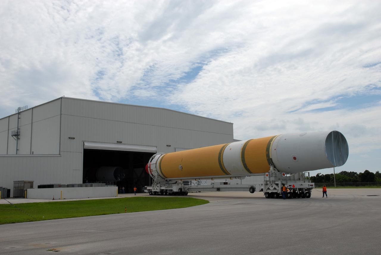 CAPE CANAVERAL, Fla. – The United Launch Alliance Delta IV first stage rolls toward the Horizontal Integration Facility on Cape Canaveral Air Force Station's Launch Complex 37. The Delta IV is the launch vehicle for the latest Geostationary Operational Environmental Satellite, known as GOES-P, developed by NASA for the National Oceanic and Atmospheric Administration, or NOAA.  Photo credit: NASA/Jim Grossmann