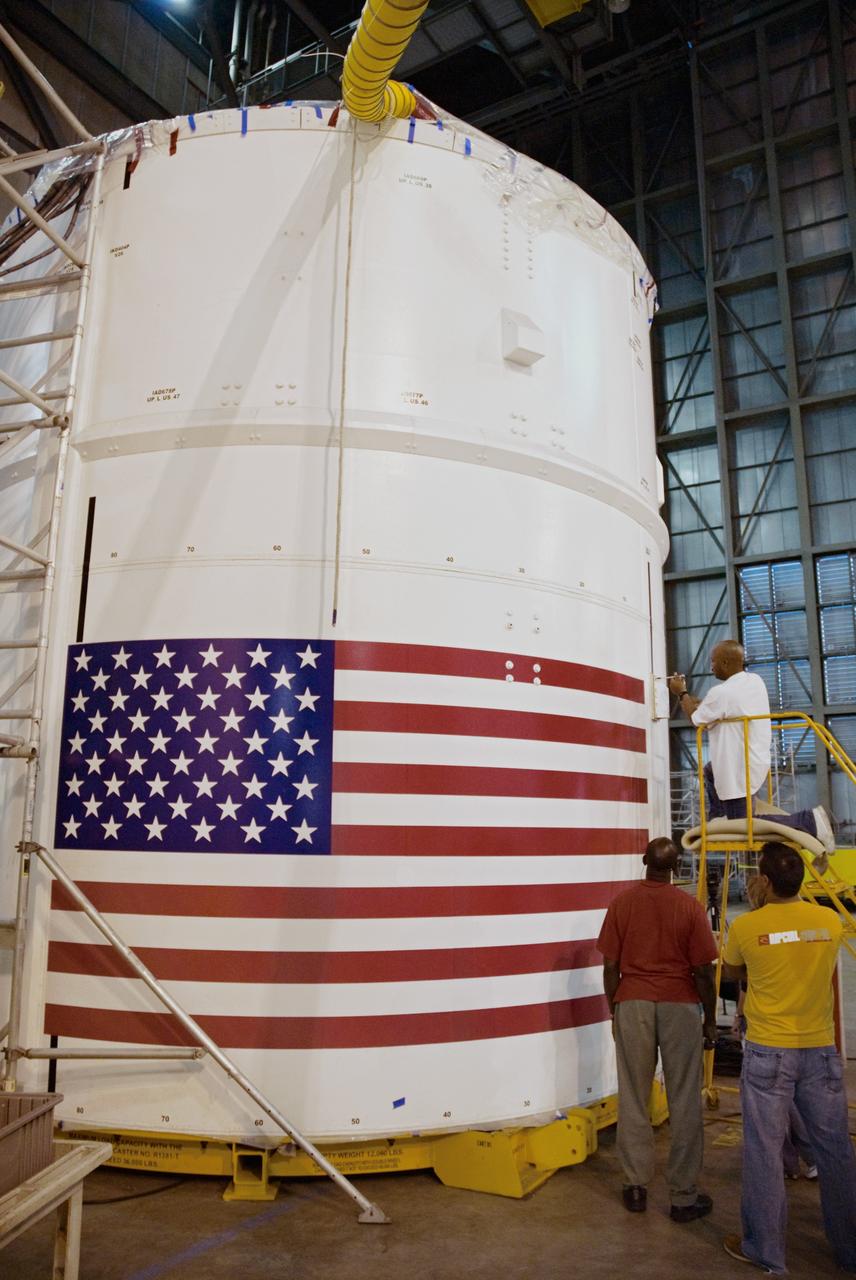 CAPE CANAVERAL, Fla. – In the Vehicle Assembly Building's High Bay 4 at NASA's Kennedy Space Center in Florida, technician Troy Merrick, with United Space Alliance, finishes installing a video camera on the side of the Ares I-X segments 6 and 7. The downward facing camera will provide live video during launch. Part of the Constellation Program, the Ares I-X is the test vehicle for the Ares I, which is the essential core of a space transportation system that eventually will carry crewed missions back to the moon, on to Mars and out into the solar system . The Ares I-X flight test is targeted for no earlier than Aug. 30. Photo credit: NASA/Jack Pfaller