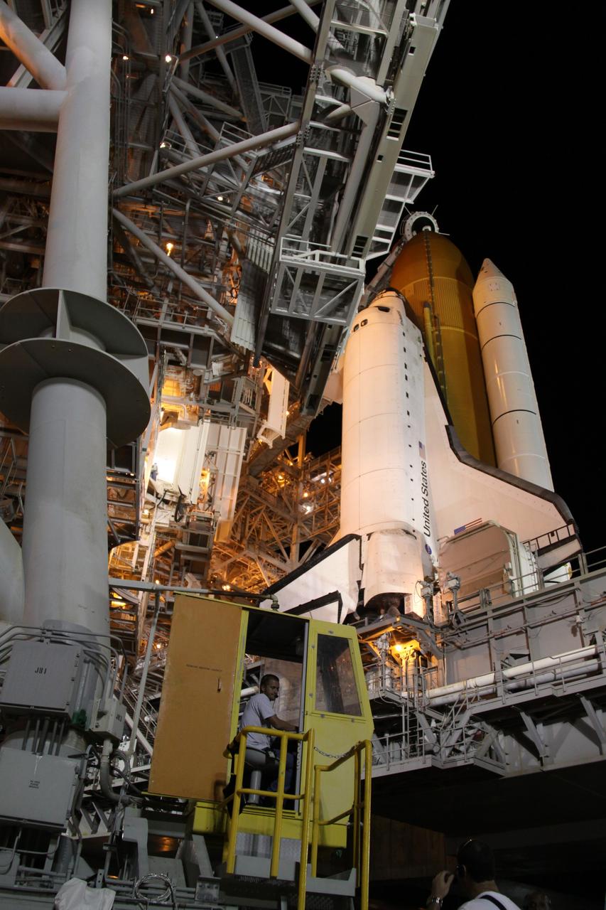 CAPE CANAVERAL, Fla. – On Launch Pad 39A at NASA's Kennedy Space Center in Florida, technicians in the control booth (lower left) begin to roll away the rotating service structure, or RSS, from space shuttle Endeavour. First motion was at 11:00 p.m. EDT. The rollback is in preparation for Endeavour's liftoff on the STS-127 mission with a crew of seven.  This is the third launch attempt for the STS-127 mission. The first two attempts on June 13 and June 17 were scrubbed when a hydrogen gas leak occurred during tanking due to a misaligned Ground Umbilical Carrier Plate.  Endeavour will deliver the Japanese Experiment Module's Exposed Facility, or JEM-EF, and the Experiment Logistics Module-Exposed Section, or ELM-ES, in the final of three flights dedicated to the assembly of the Japan Aerospace Exploration Agency's Kibo laboratory complex on the International Space Station.  STS-127 is the 29th flight for the assembly of the space station. Photo credit: NASA/Jack Pfaller