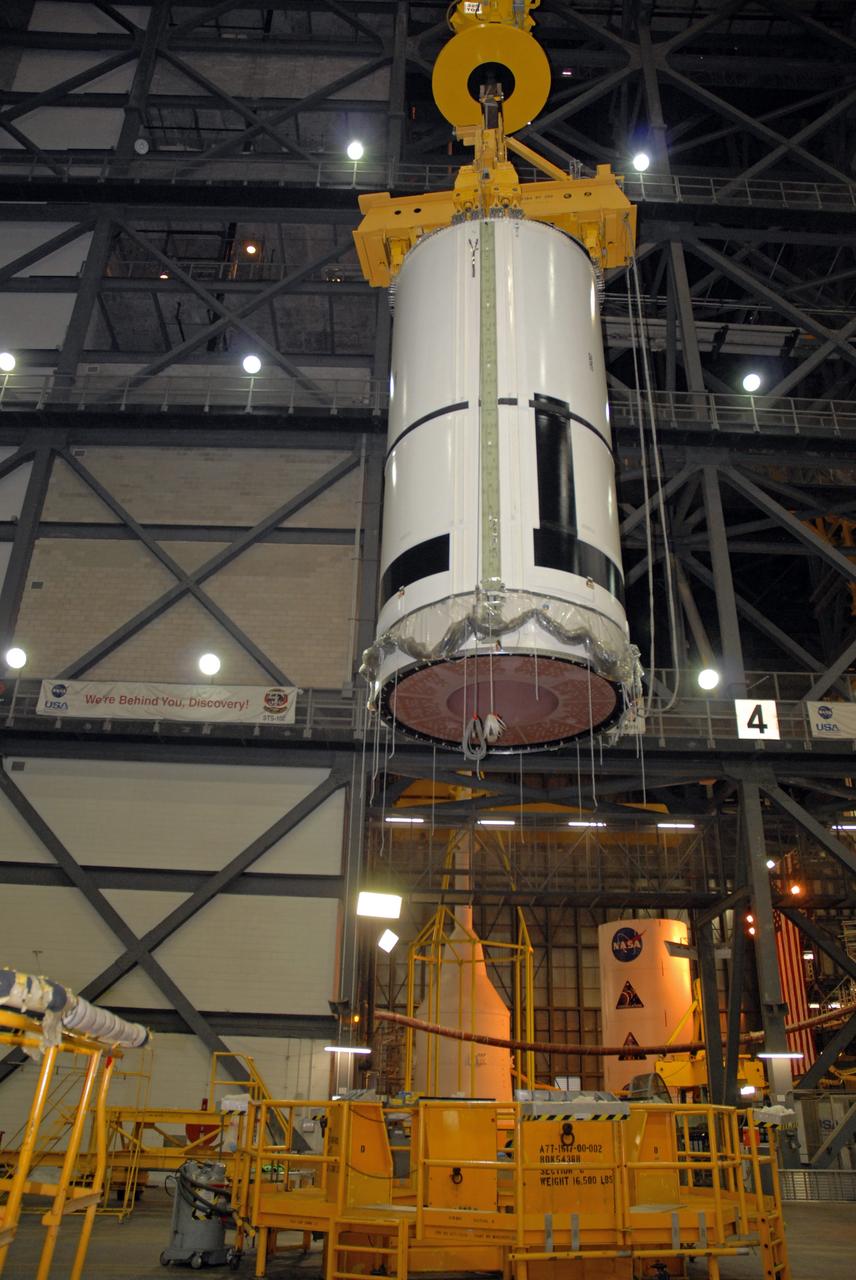 CAPE CANAVERAL, Fla. – In the Vehicle Assembly Building's transfer aisle at NASA's Kennedy Space Center in Florida, an overhead crane lifts the Ares I-X aft center booster segment, which will be lifted and then lowered into High Bay 3 for attachment to the aft booster and skirt. Part of the Constellation Program, the Ares I-X is the test vehicle for the Ares I, which is the essential core of a space transportation system that eventually will carry crewed missions back to the moon, on to Mars and out into the solar system . The flight test of the Ares I-X is targeted for no earlier than Aug. 30. Photo credit: NASA/Tim Jacobs