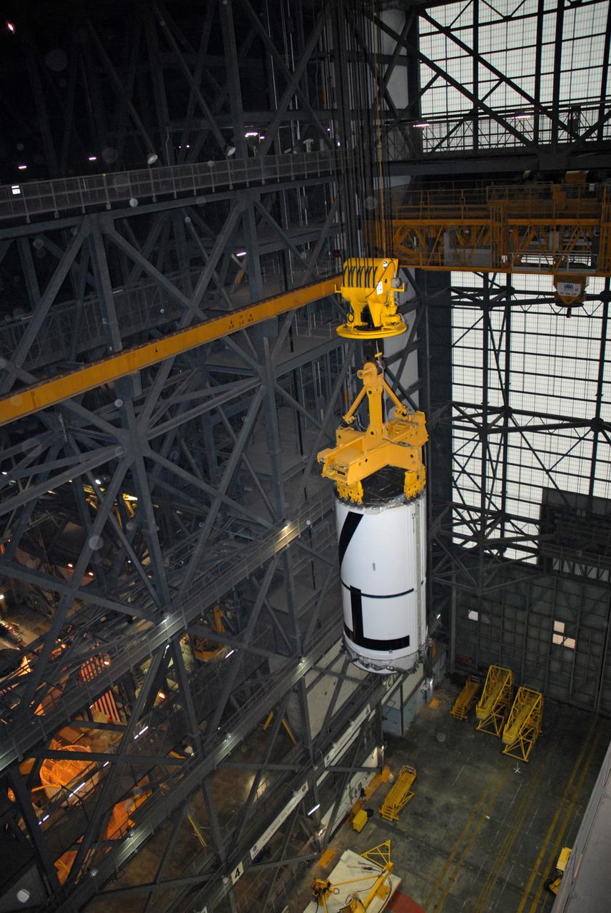 CAPE CANAVERAL, Fla. – In the Vehicle Assembly Building's transfer aisle at NASA's Kennedy Space Center in Florida, an overhead crane lifts the Ares I-X aft center booster segment , which will be lifted and then lowered into High Bay 3 for attachment to the aft booster and skirt. Part of the Constellation Program, the Ares I-X is the test vehicle for the Ares I, which is the essential core of a space transportation system that eventually will carry crewed missions back to the moon, on to Mars and out into the solar system . The flight test of the Ares I-X is targeted for no earlier than Aug. 30. Photo credit: NASA/Tim Jacobs