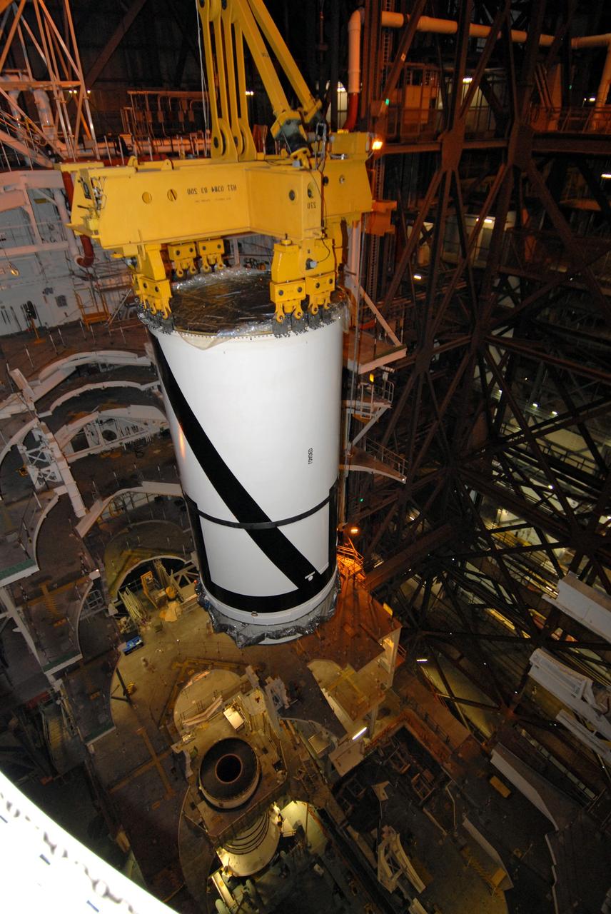 CAPE CANAVERAL, Fla. – In the Vehicle Assembly Building's transfer aisle at NASA's Kennedy Space Center in Florida, an overhead crane lowers the Ares I-X aft center booster segment toward the aft booster and skirt in High Bay 3. Part of the Constellation Program, the Ares I-X is the test vehicle for the Ares I, which is the essential core of a space transportation system that eventually will carry crewed missions back to the moon, on to Mars and out into the solar system . The flight test of the Ares I-X is targeted for no earlier than Aug. 30. Photo credit: NASA/Tim Jacobs