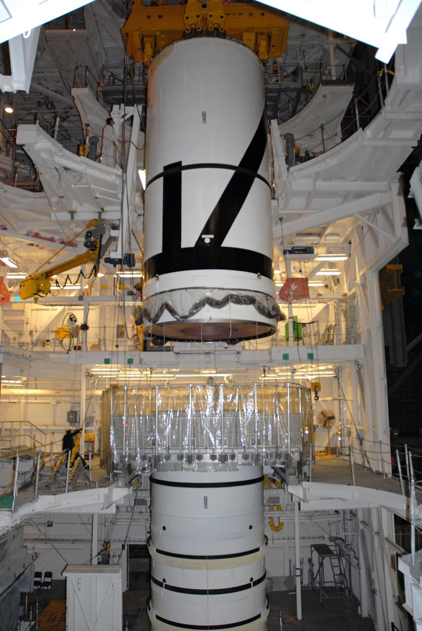 CAPE CANAVERAL, Fla. – In the Vehicle Assembly Building's transfer aisle at NASA's Kennedy Space Center in Florida, an overhead crane lowers the Ares I-X aft center booster segment toward the aft booster and skirt in High Bay 3. Part of the Constellation Program, the Ares I-X is the test vehicle for the Ares I, which is the essential core of a space transportation system that eventually will carry crewed missions back to the moon, on to Mars and out into the solar system . The flight test of the Ares I-X is targeted for no earlier than Aug. 30. Photo credit: NASA/Tim Jacobs