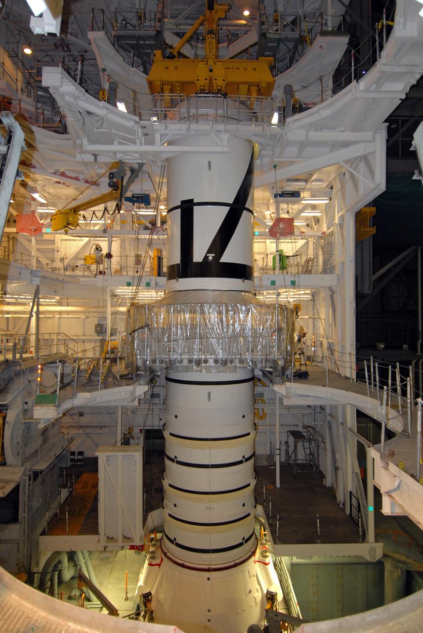 CAPE CANAVERAL, Fla. – In the Vehicle Assembly Building's High Bay 3 at NASA's Kennedy Space Center in Florida, the Ares I-X aft center booster segment is lowered onto the aft booster and skirt for mating. Part of the Constellation Program, the Ares I-X is the test vehicle for the Ares I, which is the essential core of a space transportation system that eventually will carry crewed missions back to the moon, on to Mars and out into the solar system . The flight test of the Ares I-X is targeted for no earlier than Aug. 30. Photo credit: NASA/Tim Jacobs
