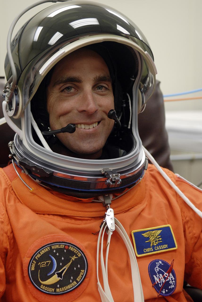 CAPE CANAVERAL, Fla. – In the Operations and Checkout Building at NASA's Kennedy Space Center in Florida, STS-127 crew members put on their launch-and-entry suits before heading to the Astrovan for the 3.4-mile drive to Launch Pad 39A.  Seen here is Mission Specialist Christopher Cassidy, who is making his first shuttle flight. At the pad, Cassidy and the other crew members will complete their suitup and enter space shuttle Endeavour for the 7:13 p.m. EDT liftoff. This is the fourth launch attempt for the STS-127 mission. The first two launch attempts on June 13 and June 17 were scrubbed when a hydrogen gas leak occurred during tanking due to a misaligned Ground Umbilical Carrier Plate. Mission managers also decided to delay tanking on July 11 for a launch attempt later in the day to allow engineers and safety personnel time to analyze data captured during lightning strikes near the pad on July 10. Endeavour will deliver the Japanese Experiment Module's Exposed Facility, or JEM-EF, and the Experiment Logistics Module-Exposed Section, or ELM-ES, in the final of three flights dedicated to the assembly of the Japan Aerospace Exploration Agency's Kibo laboratory complex on the International Space Station.  STS-127 is the 29th flight for the assembly of the space station.   Photo credit: NASA/Kim Shiflett