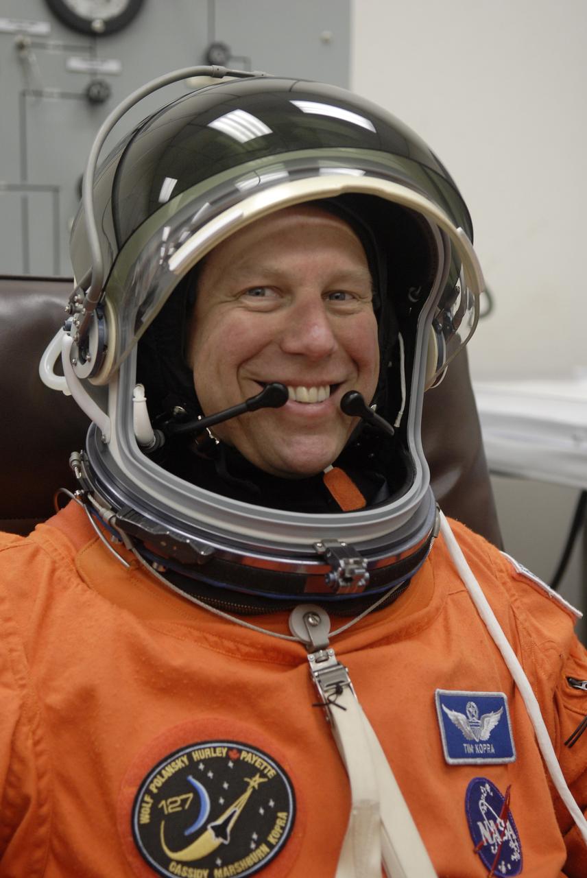 CAPE CANAVERAL, Fla. – In the Operations and Checkout Building at NASA's Kennedy Space Center in Florida, STS-127 crew members put on their launch-and-entry suits before heading to the Astrovan for the 3.4-mile drive to Launch Pad 39A. Seen here is Mission Specialist Tim Kopra, who is checking his helmet. At the pad, he and the other crew members will complete their suitup and enter space shuttle Endeavour for the 7:13 p.m. EDT liftoff. Kopra will remain on the International Space Station as the Expedition 20 flight engineer. This is the fourth launch attempt for the STS-127 mission. The first two launch attempts on June 13 and June 17 were scrubbed when a hydrogen gas leak occurred during tanking due to a misaligned Ground Umbilical Carrier Plate. Mission managers also decided to delay tanking on July 11 for a launch attempt later in the day to allow engineers and safety personnel time to analyze data captured during lightning strikes near the pad on July 10. Endeavour will deliver the Japanese Experiment Module's Exposed Facility, or JEM-EF, and the Experiment Logistics Module-Exposed Section, or ELM-ES, in the final of three flights dedicated to the assembly of the Japan Aerospace Exploration Agency's Kibo laboratory complex on the International Space Station. STS-127 is the 29th flight for the assembly of the space station. Photo credit: NASA/Kim Shiflett
